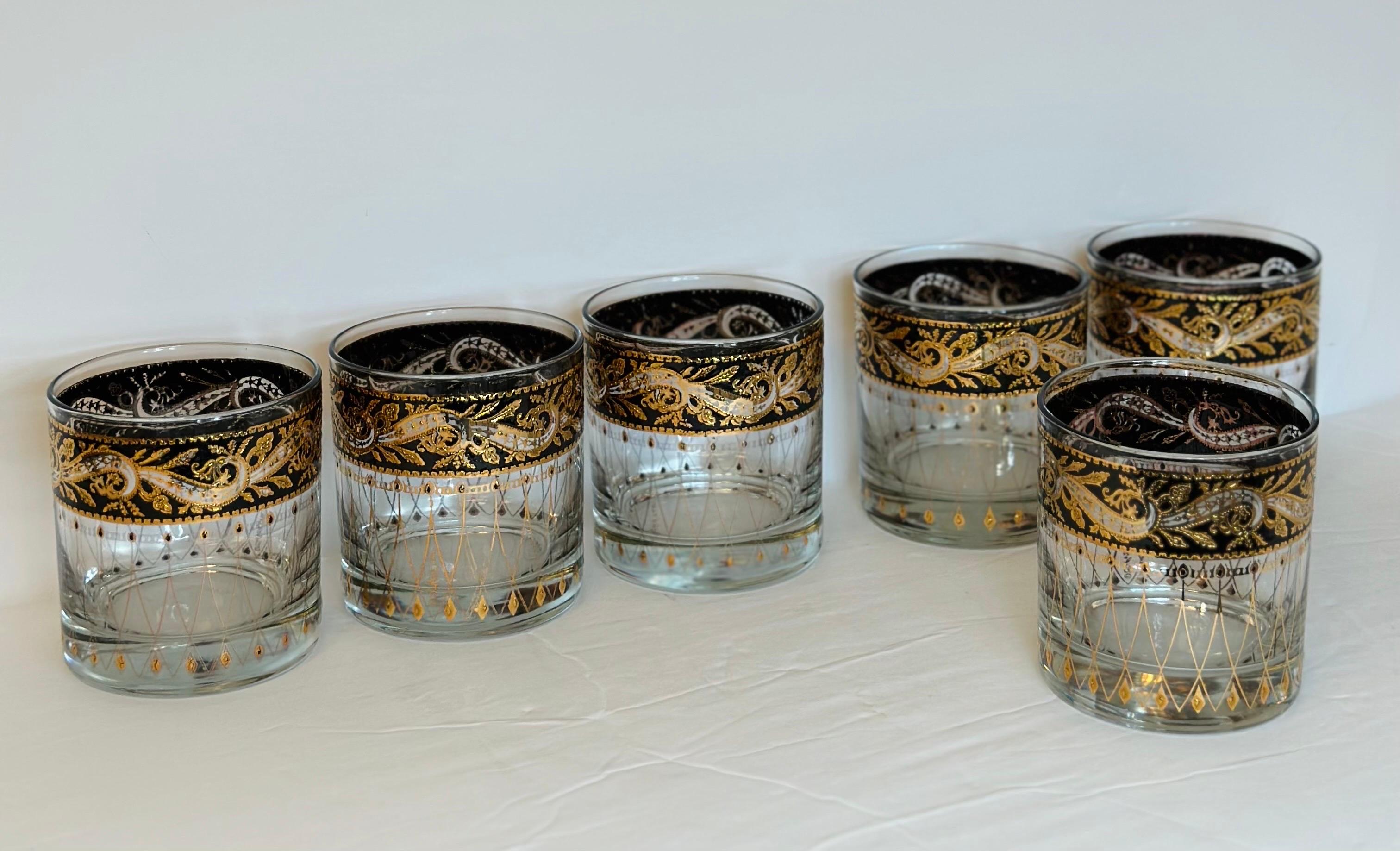 We are very pleased to offer an exquisite set of six glasses, by Culver, circa the 1960s.  This set epitomizes the quintessential Mid-century modern design era with a captivating leaf pattern, enriched by the presence of intricate gold and black