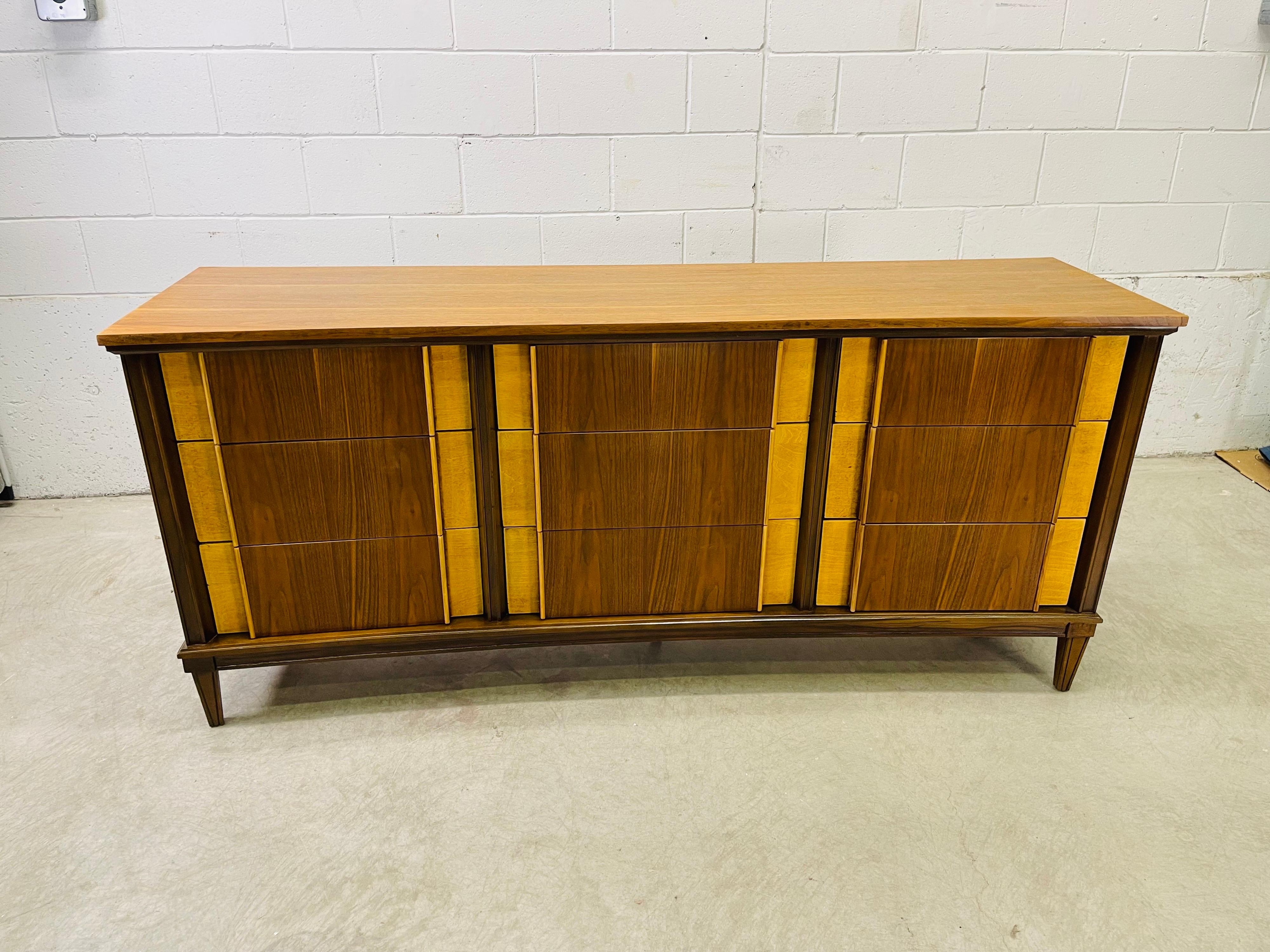 Vintage 1960s curved front two tone walnut and maple wood low dresser with nine drawers. The drawers have the maple wood on the sides. The drawers are 4-6.5”H. Great curved design. Newly refinished condition. No marks.