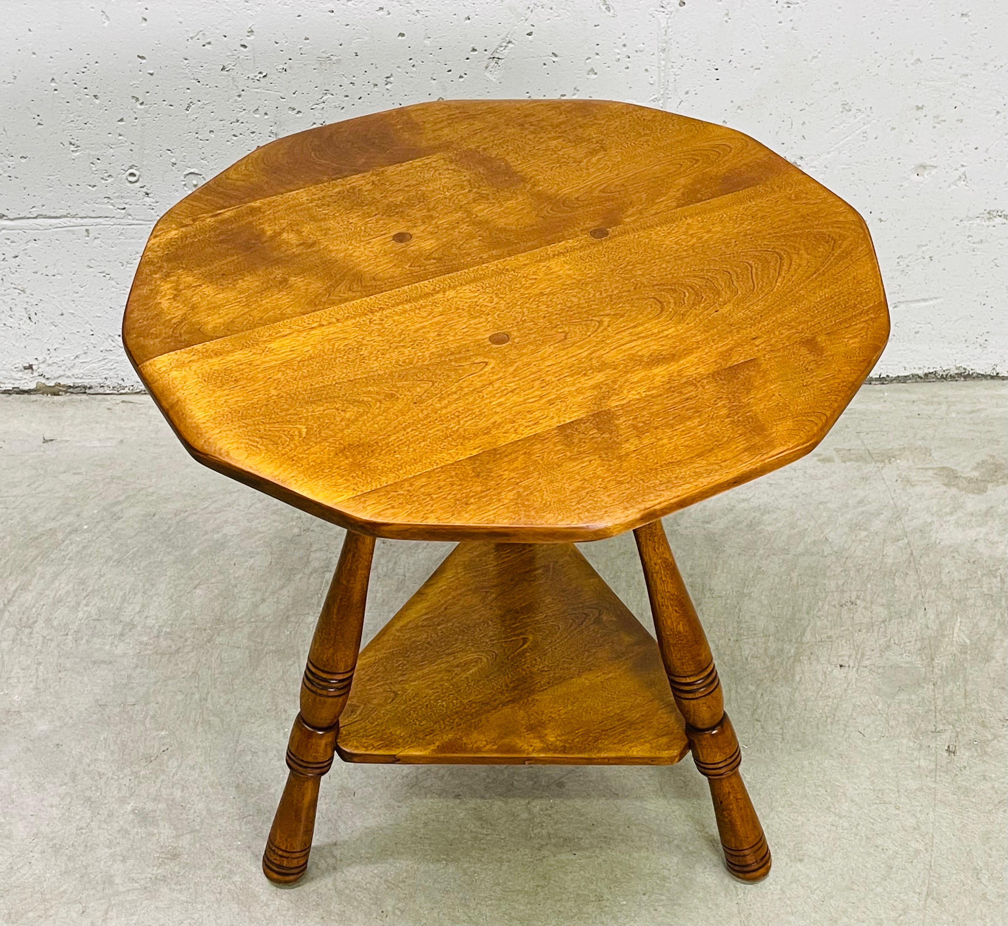 Vintage 1960s maple wood side table by Cushman of Vermont. The table has twelve sides with an additional shelf underneath for storage. Peg joinery is visible as an accent on the top. Excellent refinshed condition. Marked underneath.