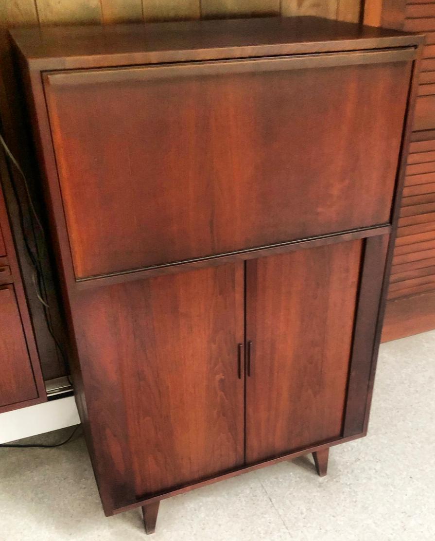 Gorgeous walnut cabinet custom built for Greenwich, CT home in the 1960s. Gorgeous deep color and patina. In very good condition. Features lower tambourine doors and walnut drop down cabinet for use as bar or storage.