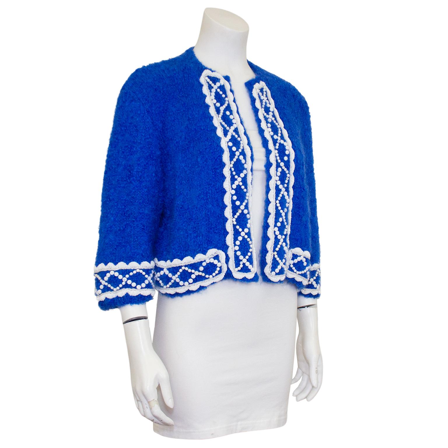 1960's custom knit royal blue mohair bolero cardigan. The perfect added touch for your summer cottons. 1960's custom knit mohair 3/4 sleeve bolero with white hand sewn beaded trim. This was an extremely skilled knitter who showcased her talents on