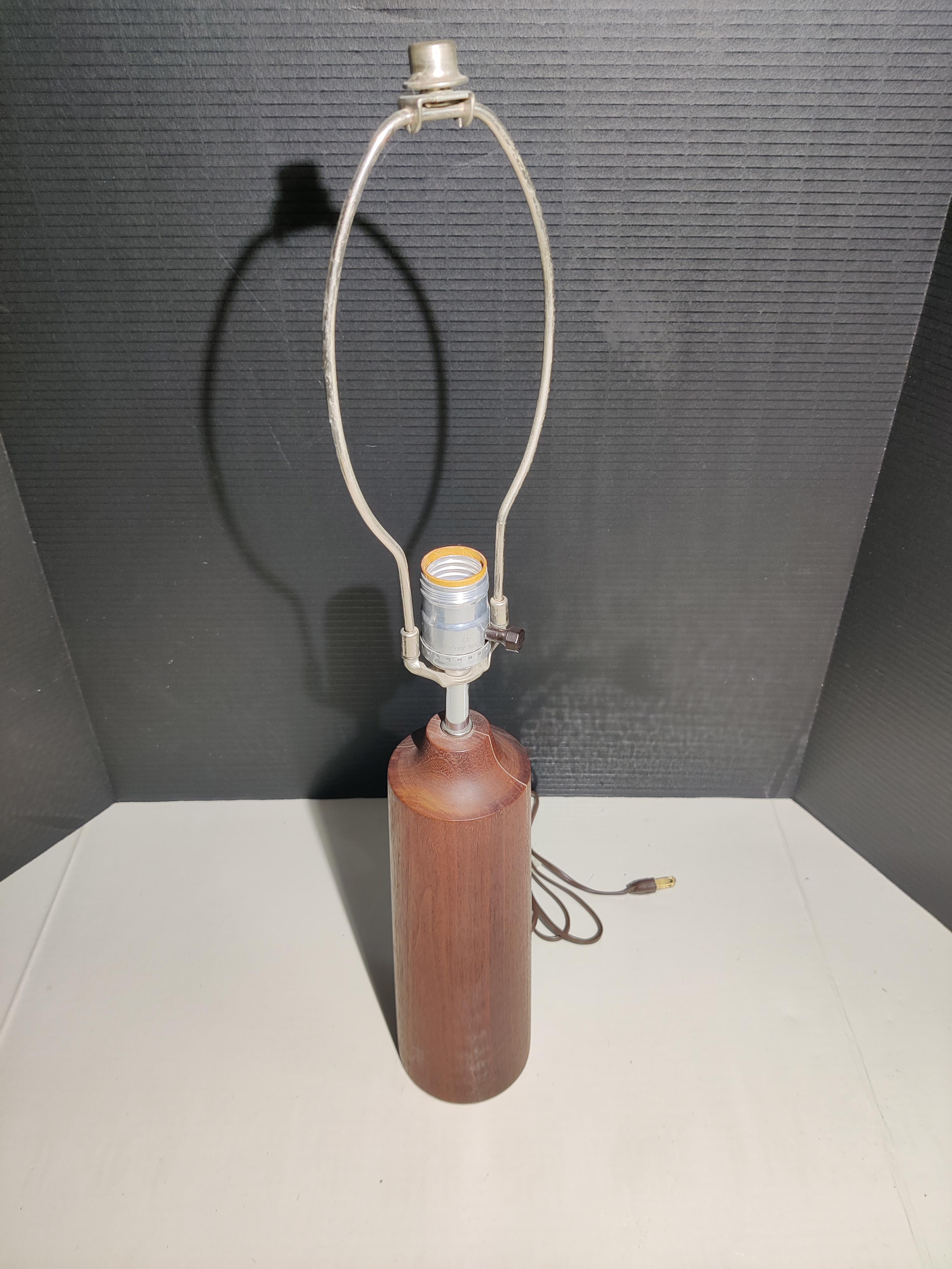 1960s cylinder shaped teak lamp 
Scandinavian mid-century modern. 
Hairline crack running down side of lamp. 
The rest of wood is in good condition.
Lamp is working.
Has basic finial. 
