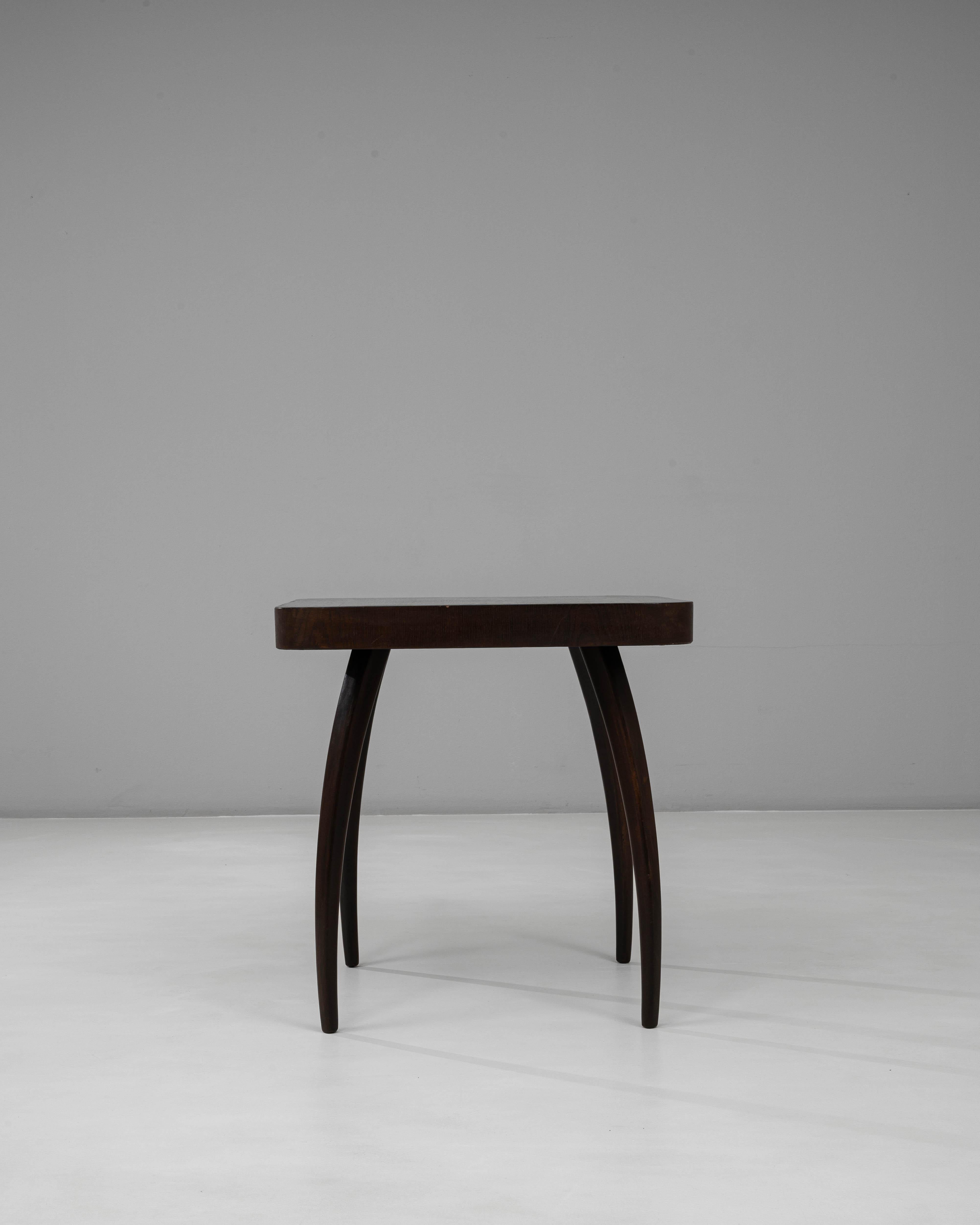 This 1960s Czech “Spider” table by Jindřich Halabala captures the sculptural elegance and refined craftsmanship characteristic of his mid-century designs. The table features a distinctive silhouette with four gracefully arched legs, creating a sense