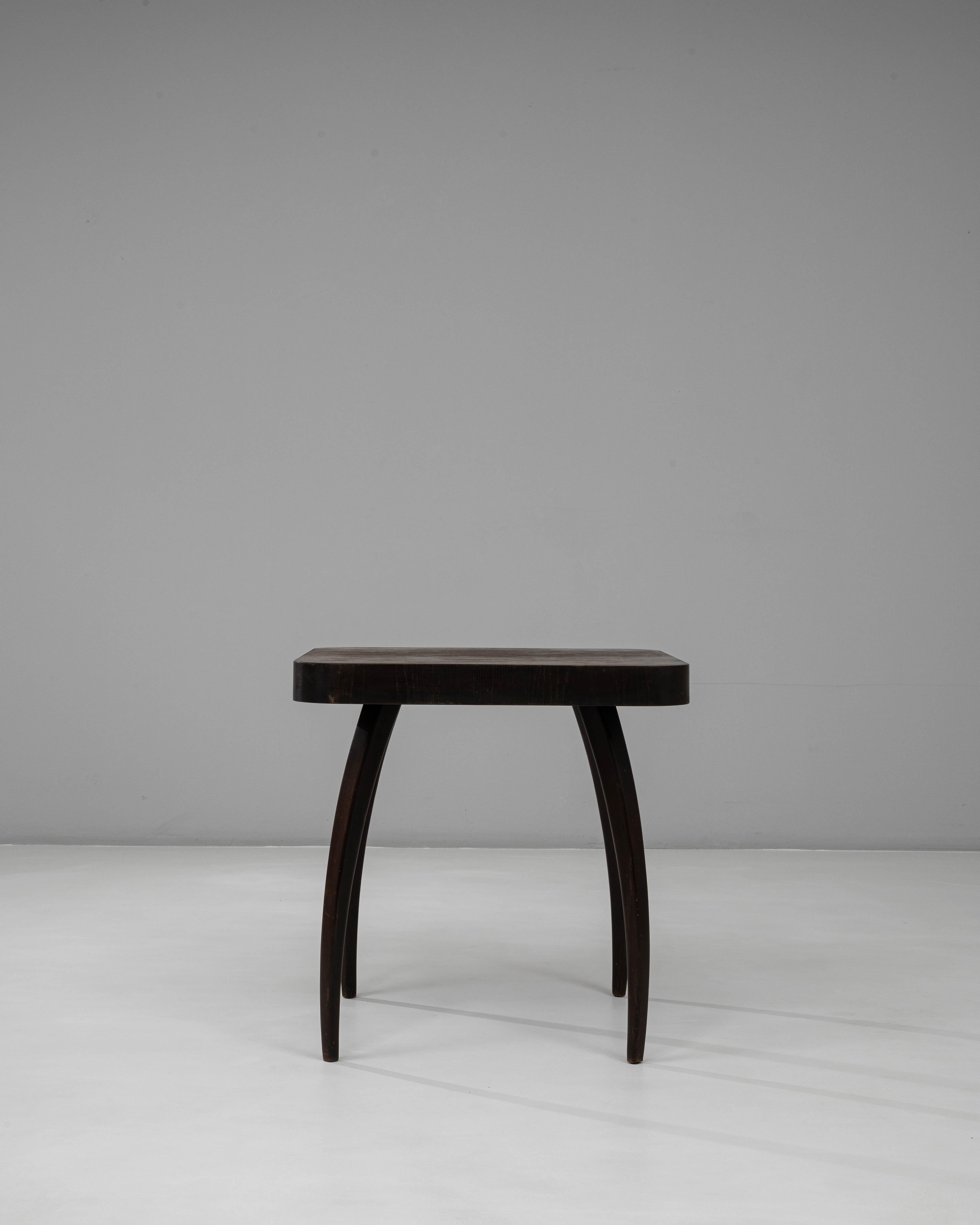 This 1960s Czech “Spider” table by Jindřich Halabala captures the sculptural elegance and refined craftsmanship characteristic of his mid-century designs. The table features a distinctive silhouette with four gracefully arched legs, creating a sense