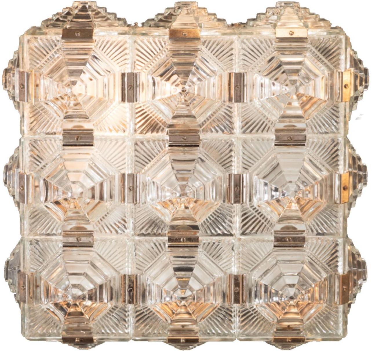 A pair of wonderful, modern 1960s glass pendants. Manufactured by Kamenicky. Czechoslovakia, 1960s. Newly rewired.

This stunning pair of sculptural translucent light fixtures by Kamenicky feature an intricate pressed glass stylized geometric