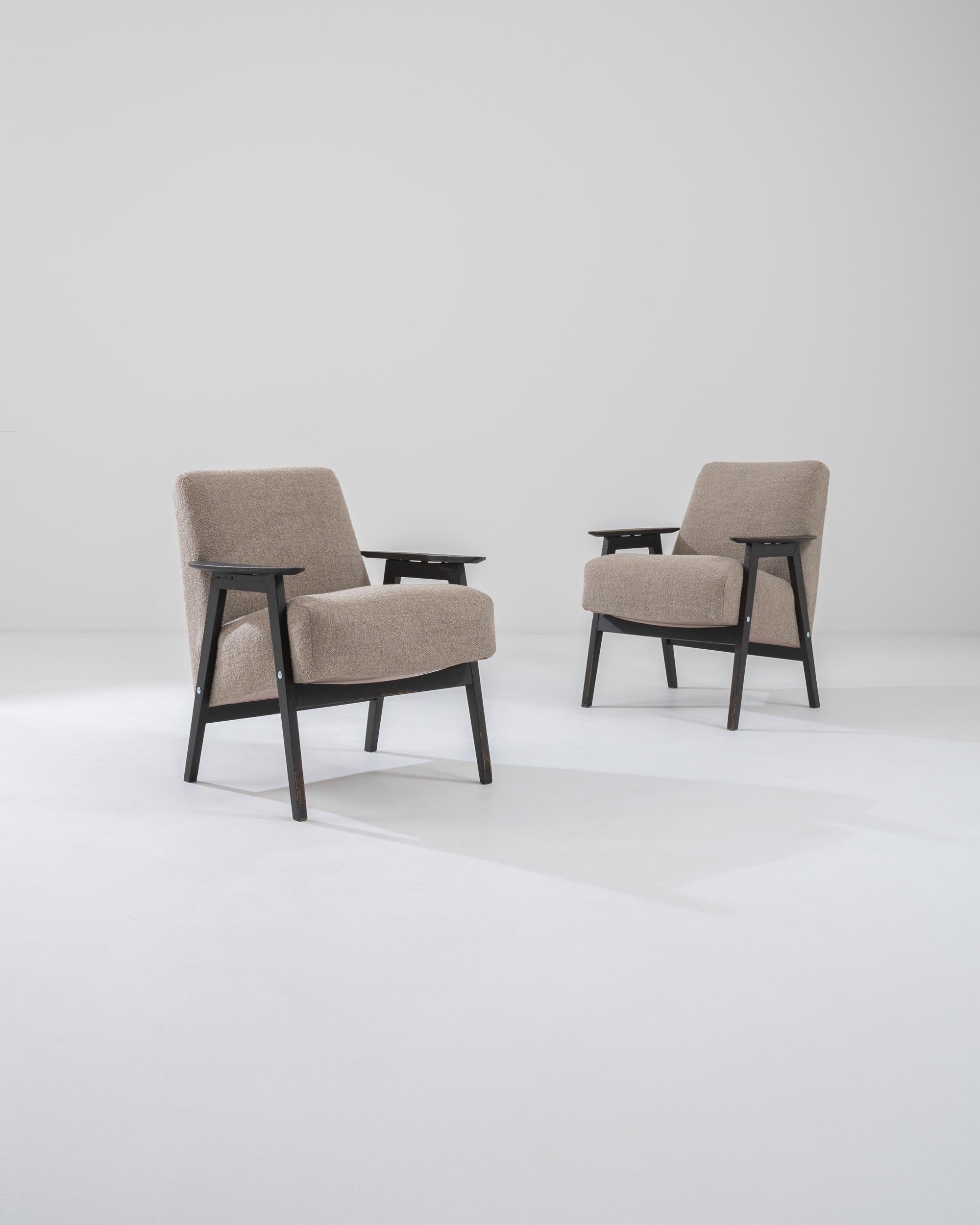 This pair of 1960s armchairs epitomizes the restful equilibrium of Czech Modernist design. The bold geometries of the frame combine clean lines with a sense of harmonious balance, while the reclined position of the generously cushioned seat creates