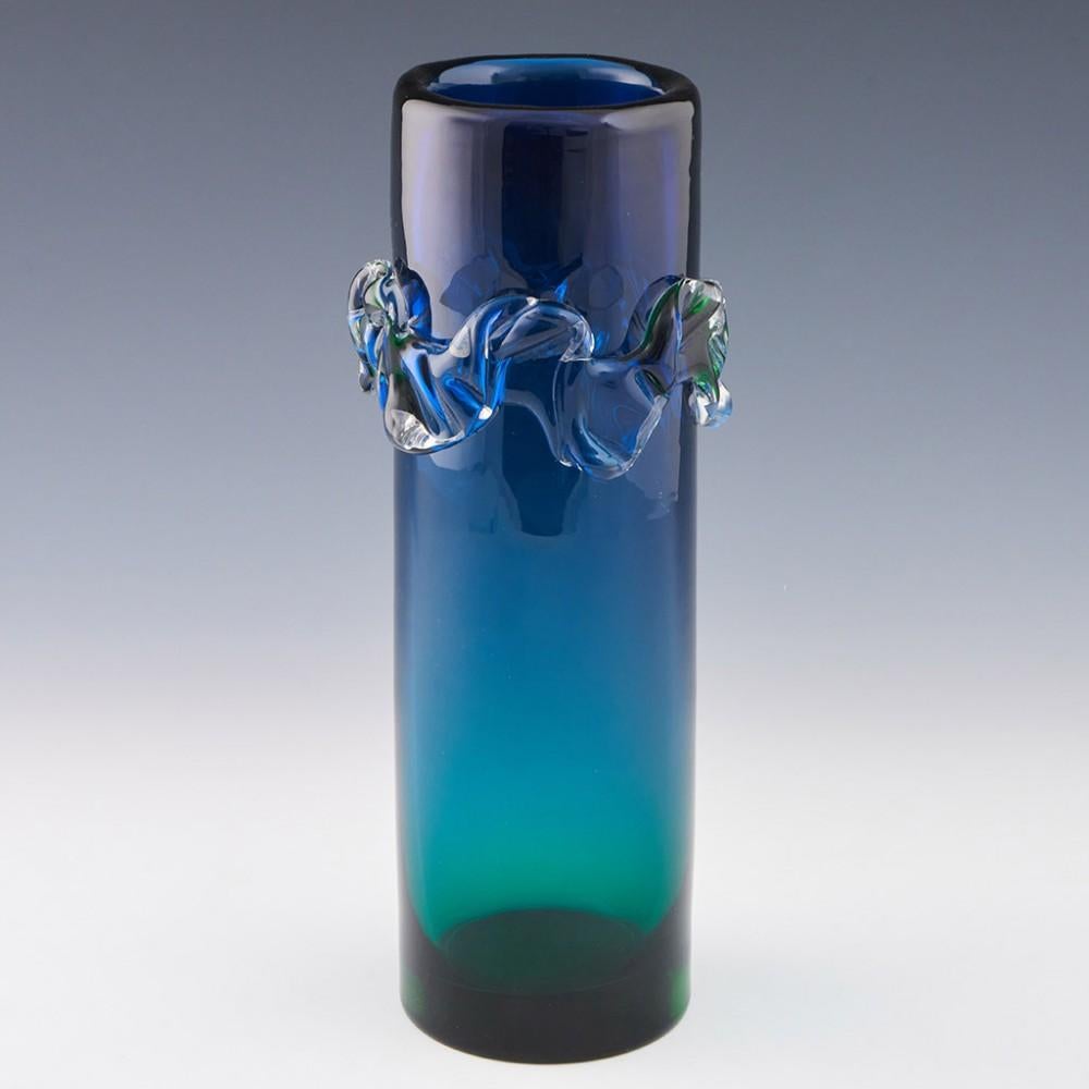 Heading :1960s Czech Skrdlovice vase
Date : Designed 1966
Origin : Czechoslovakia, now Czech Republic 
Bowl Features : Graduated green to blue (bottom to top) body with clear glass wavy band at the top of the body. This brilliant addition refracts