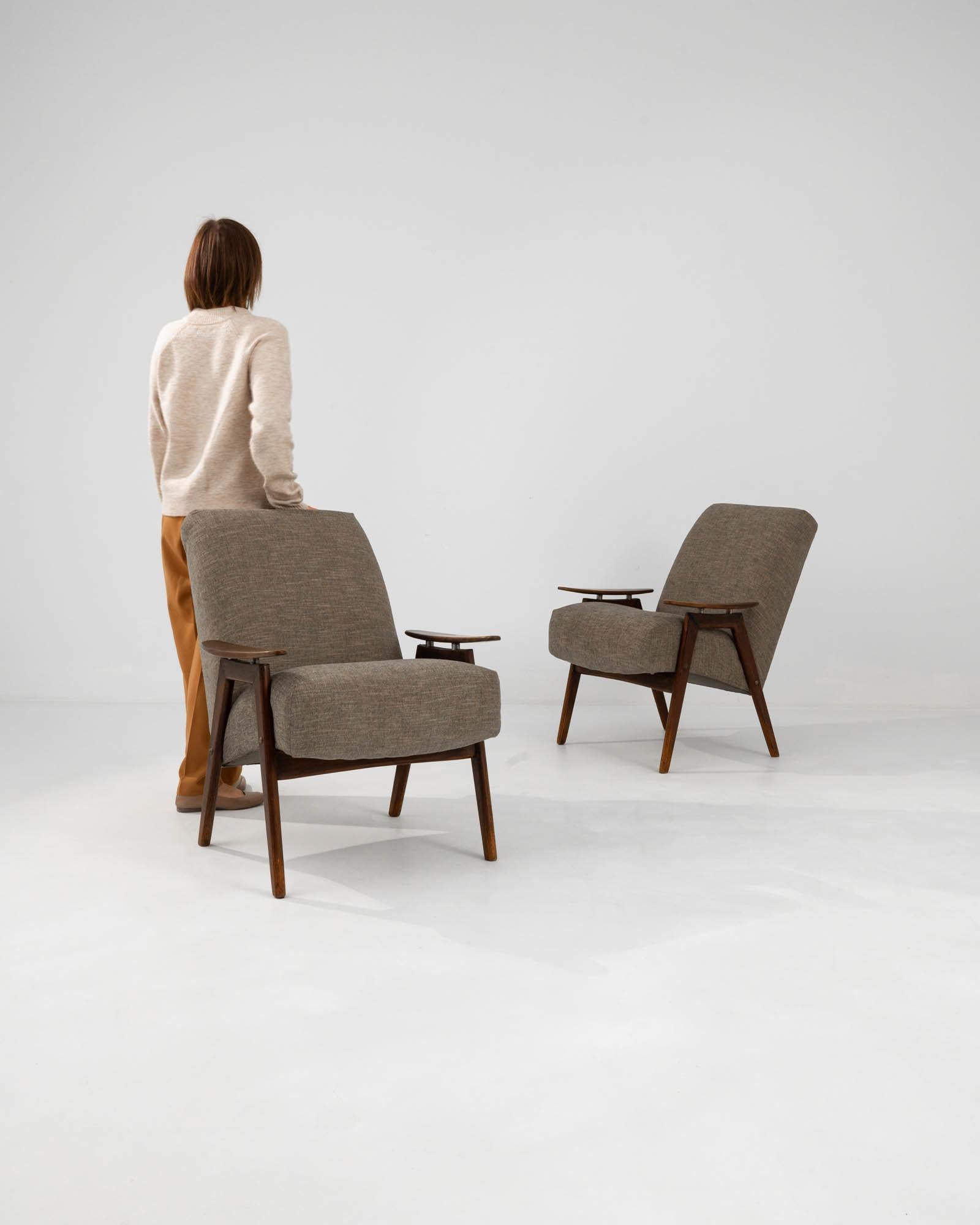 Step back into the chic era of the 1960s with this pair of Czech upholstered armchairs, a duo that exudes both elegance and comfort. Their sleek silhouette is a testament to the timeless appeal of mid-century modern design, featuring clean lines and
