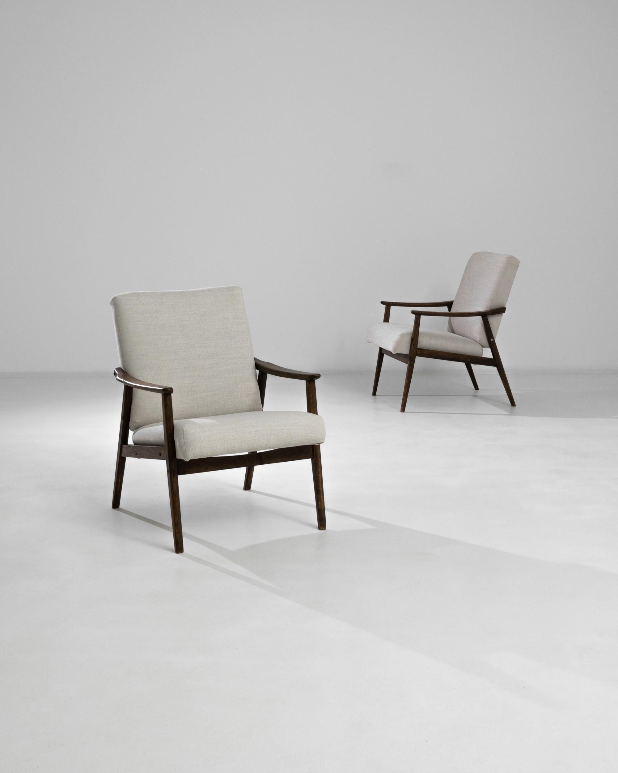 Migliora il tuo spazio abitativo con questa sofisticata coppia di poltrone imbottite ceche degli anni '60. Questi eleganti pezzi sono caratterizzati da strutture in legno dalle linee pulite e braccioli delicatamente curvi, che mettono in mostra