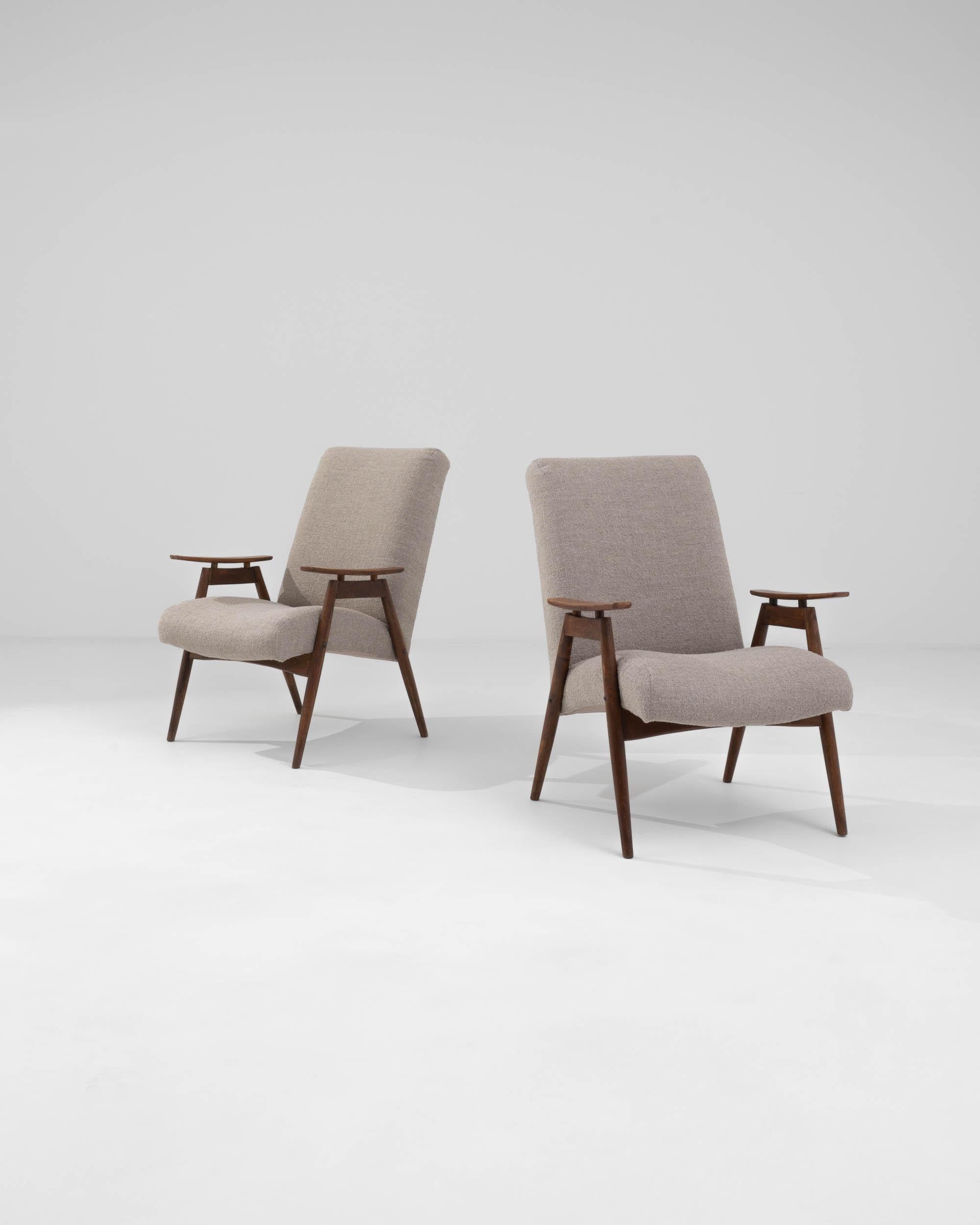 Discover the perfect blend of vintage elegance and modern comfort with this pair of 1960s Czech Upholstered Armchairs. Featuring sleek wooden frames with a warm, natural finish, these chairs are a testament to mid-century design. The high backrests