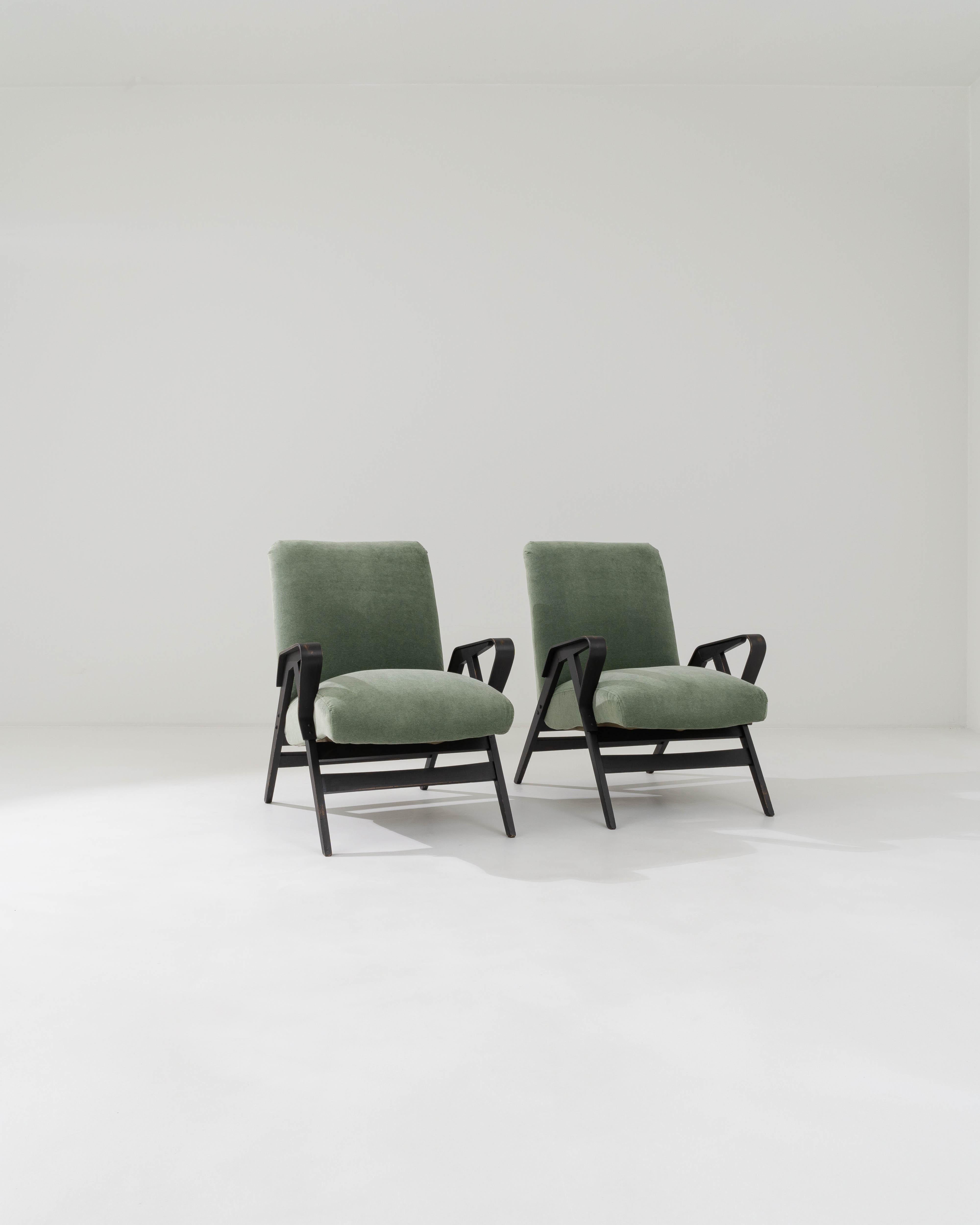 Characterized by the clean lines that define their minimalist silhouette, these armchairs were crafted by the iconic Czech brand, with the design attributed to František Jirák, in the 1960s. The smooth, contoured surfaces of the bentwood arms engage