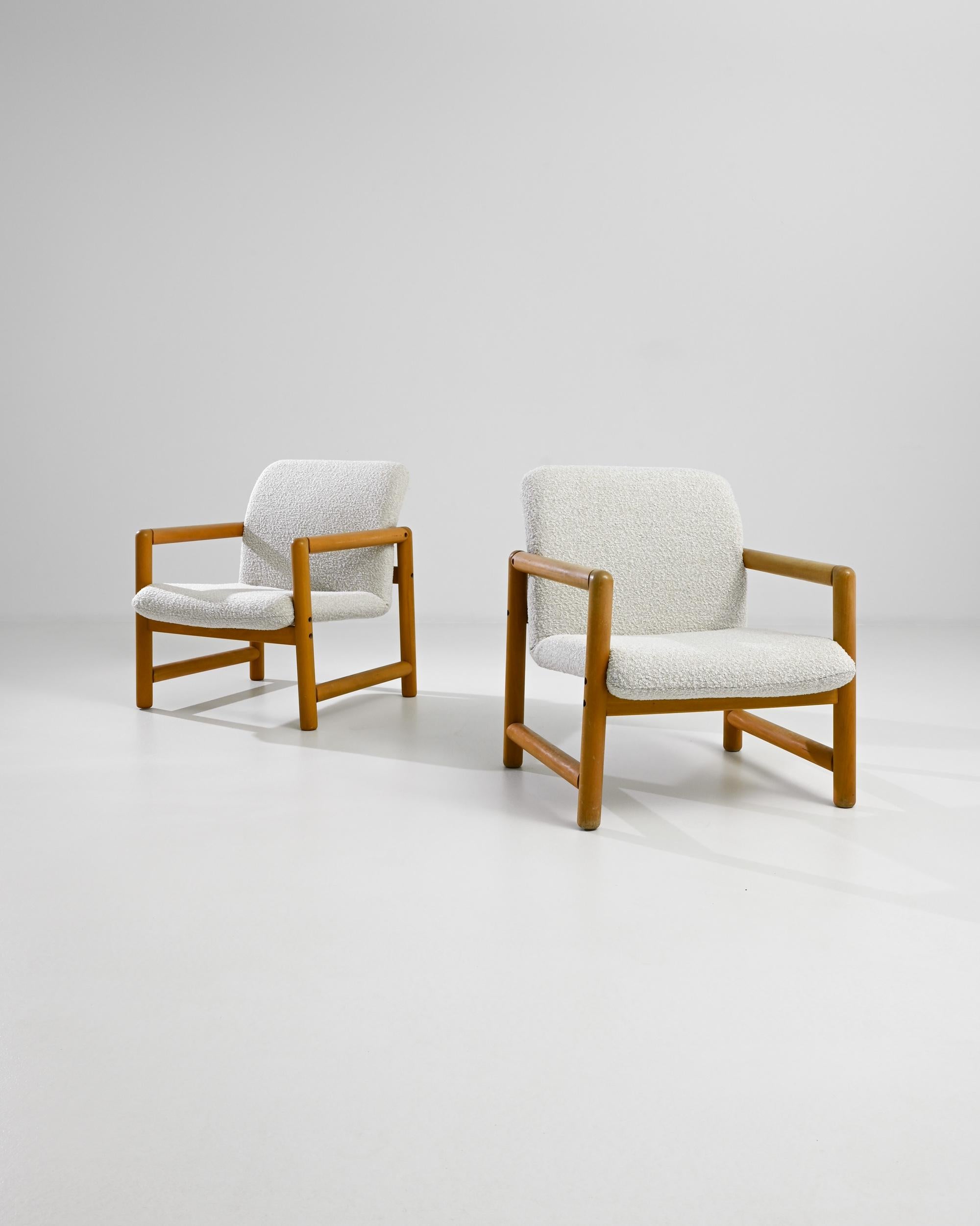 Introducing a stunning pair of 1960s Czech Upholstered Armchairs by TON, perfect for adding a touch of vintage elegance to your home. These beautifully crafted chairs feature solid wood frames with a warm, honey-toned finish, reflecting the