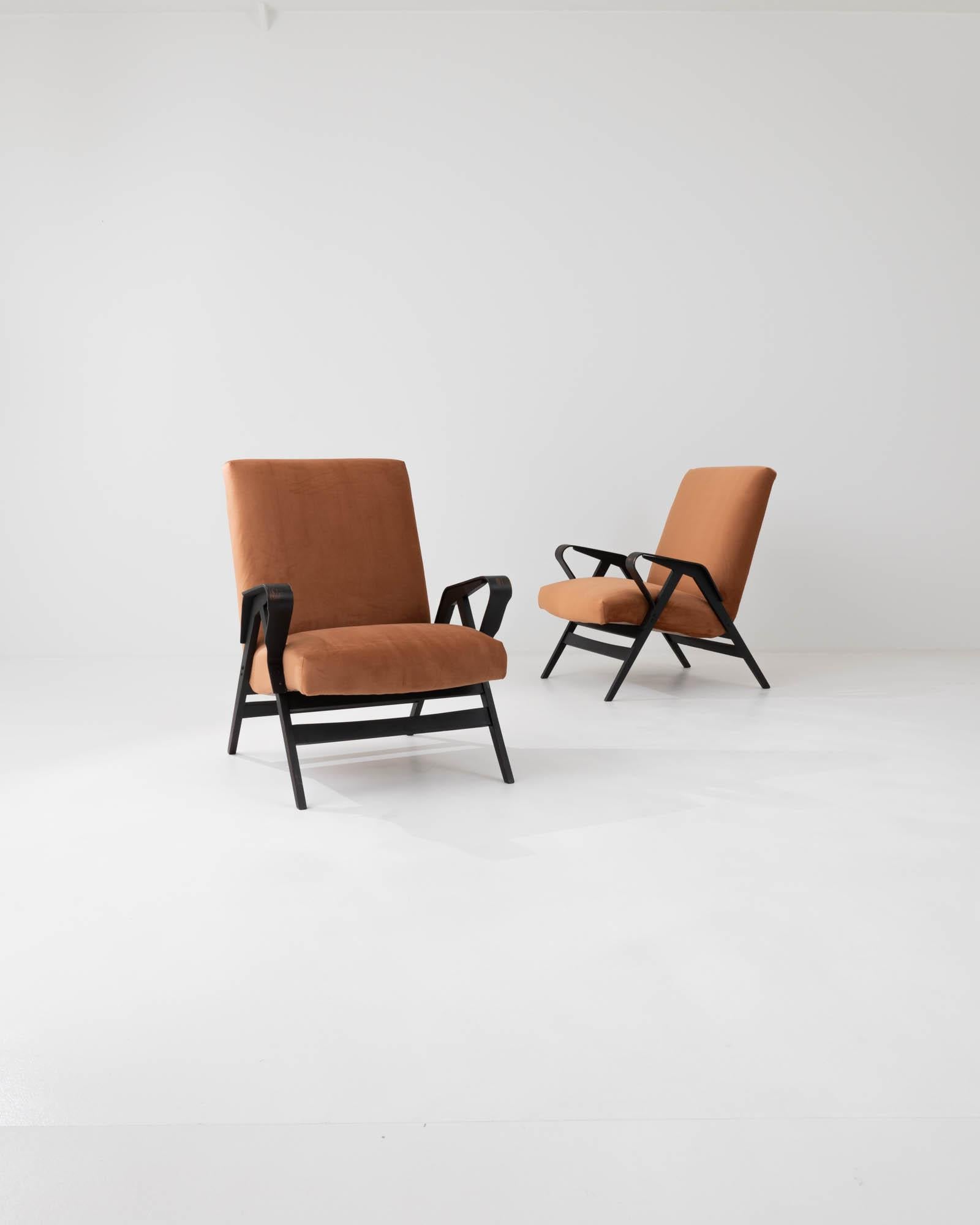 Characterized by the clean lines that define their minimalist silhouette, these armchairs were crafted by the iconic Czech brand, with the design attributed to František Jirák, in the 1960s. The smooth, contoured surfaces of the bentwood arms engage