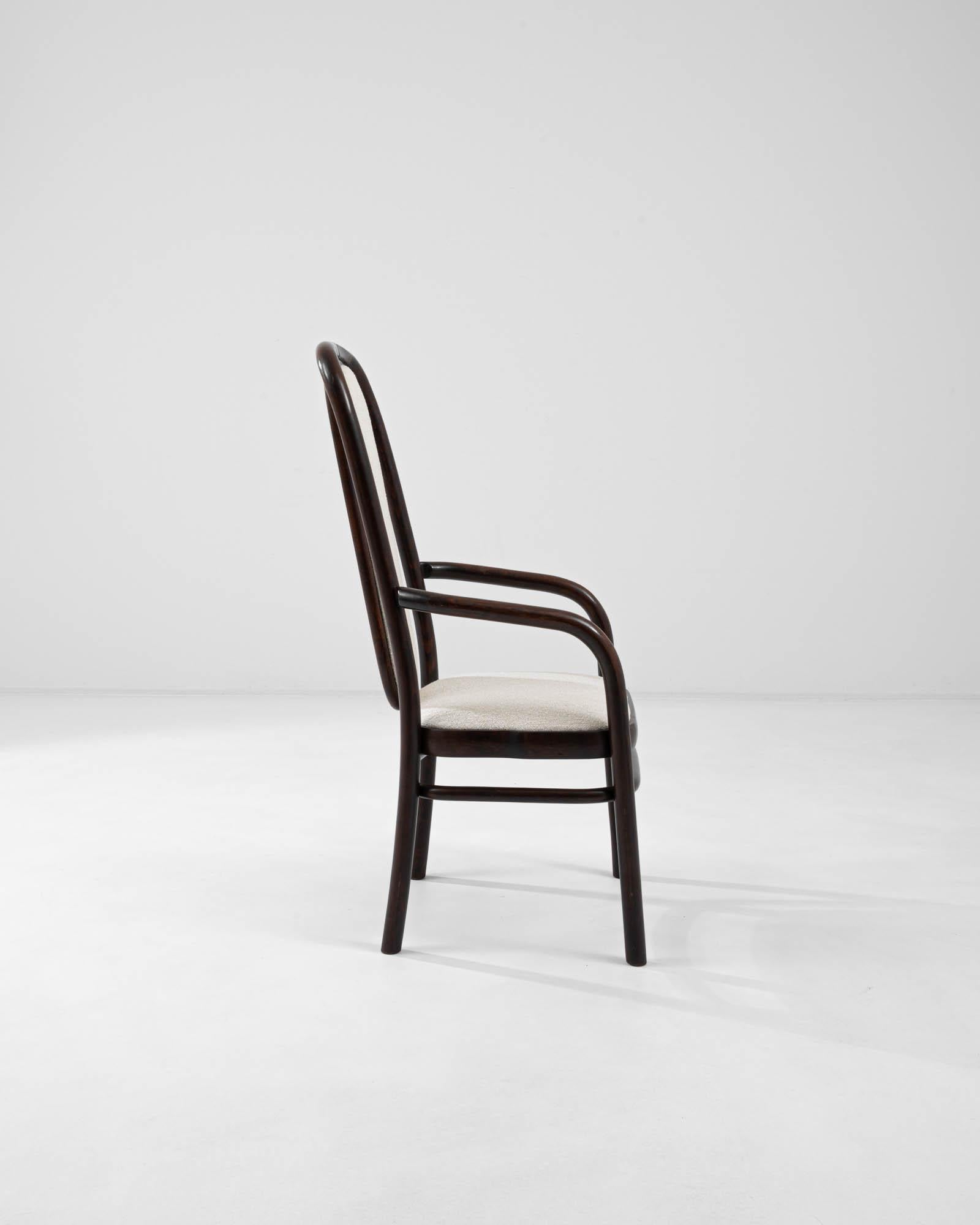 An upholstered bentwood dining chair created in 1960s Czechia by noted furniture manufacturer, TON. Characteristic of mid-century Czech design, this elegant dining table combines a sleek fashionability with a warm and approachable demeanor. The