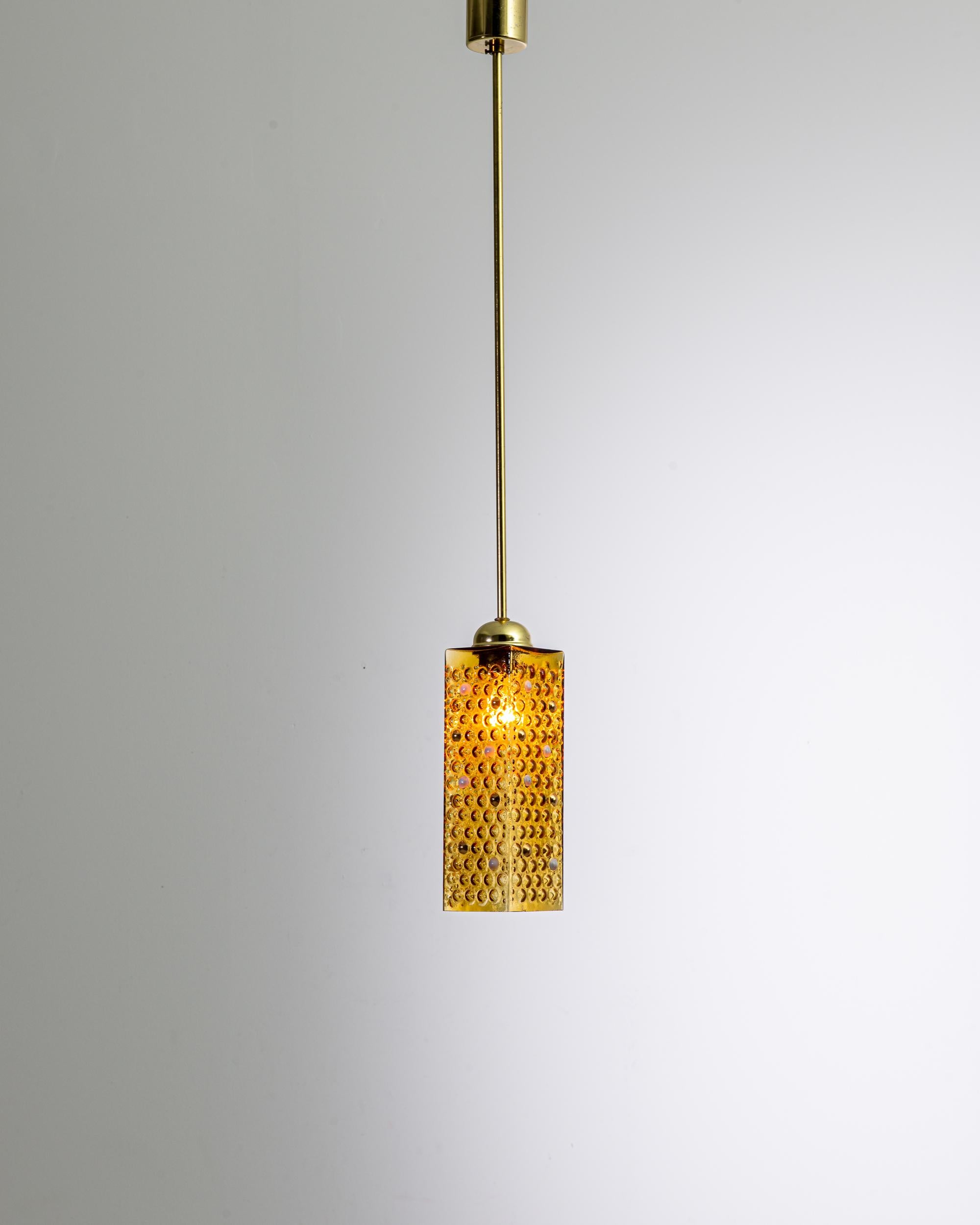Illuminate your space with the classic sophistication of our 1960s Czech Yellow Brass and Glass Pendant Lamp. This striking piece embodies the innovation of mid-century design, combining the lustrous warmth of a polished brass stem with the textured