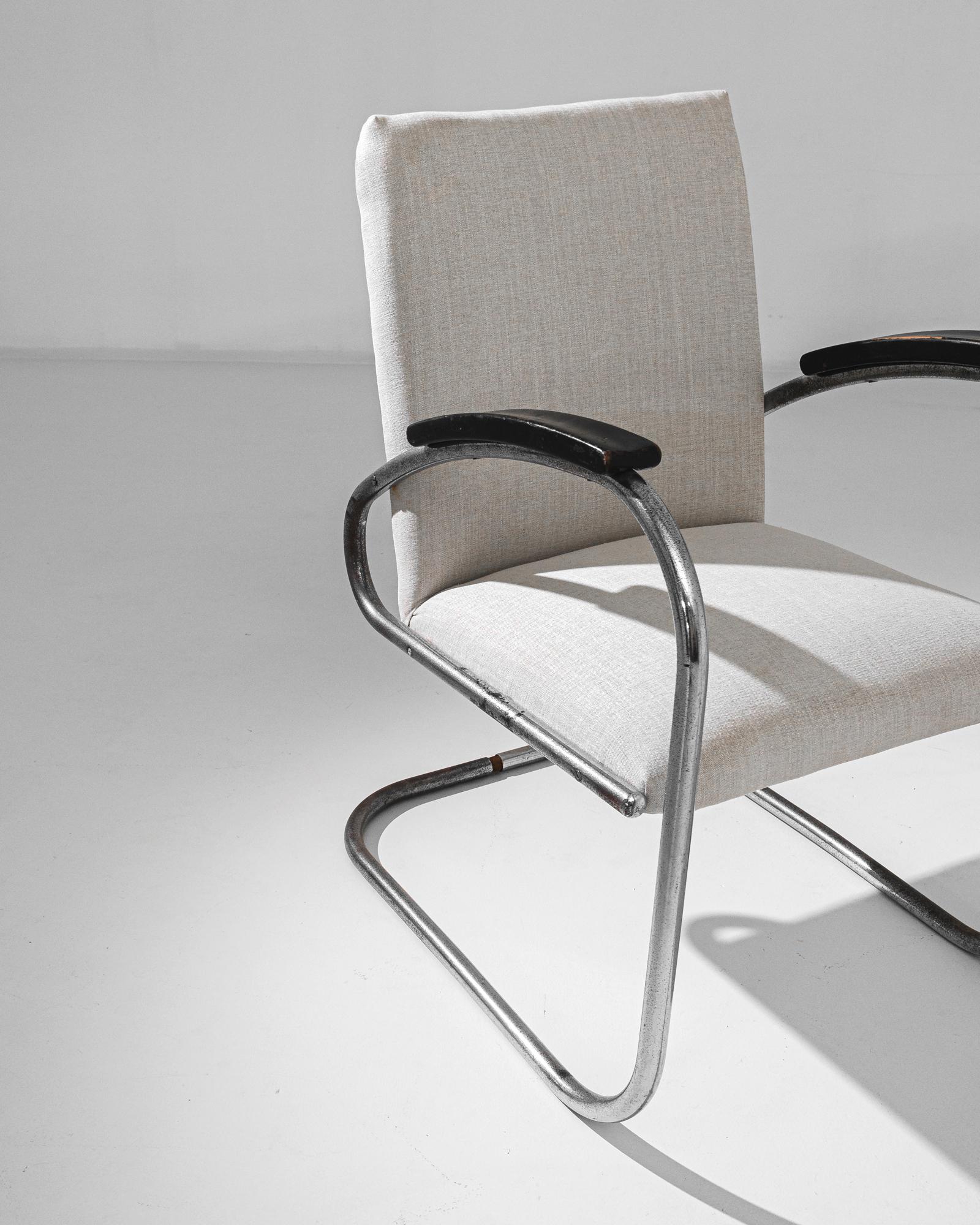 Discover the timeless elegance of the 1960s Czechia Metal Armchair. This iconic piece boasts a sleek, minimalist design featuring a sturdy metal frame with a polished chrome finish that exudes mid-century modern charm. The chair's upholstered seat