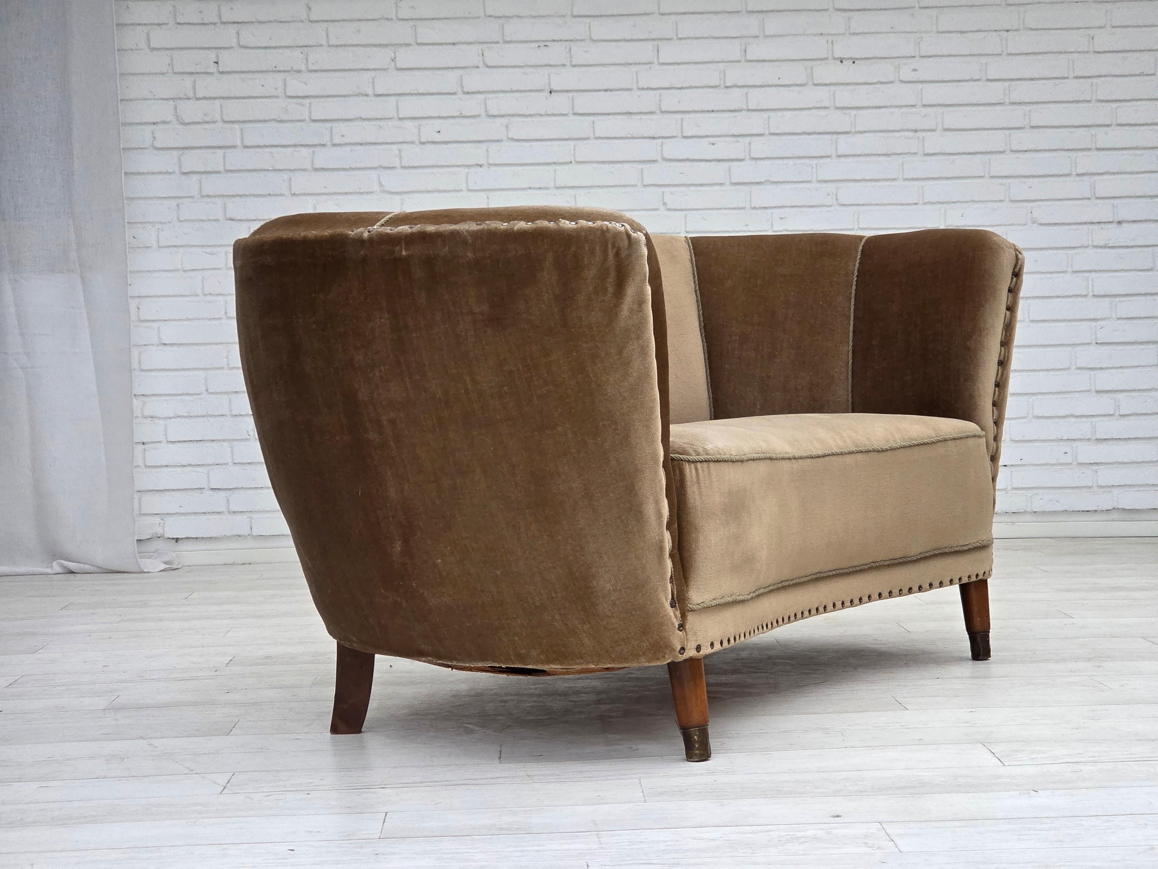 1960s, Danish 2-seater curved sofa. Green furniture velour, beech wood legs with brass plugs, brass springs in the seat. Sofa was reupholstered by craftsman about 20 years ago. Good condition: no smells, no stains and stable construction.