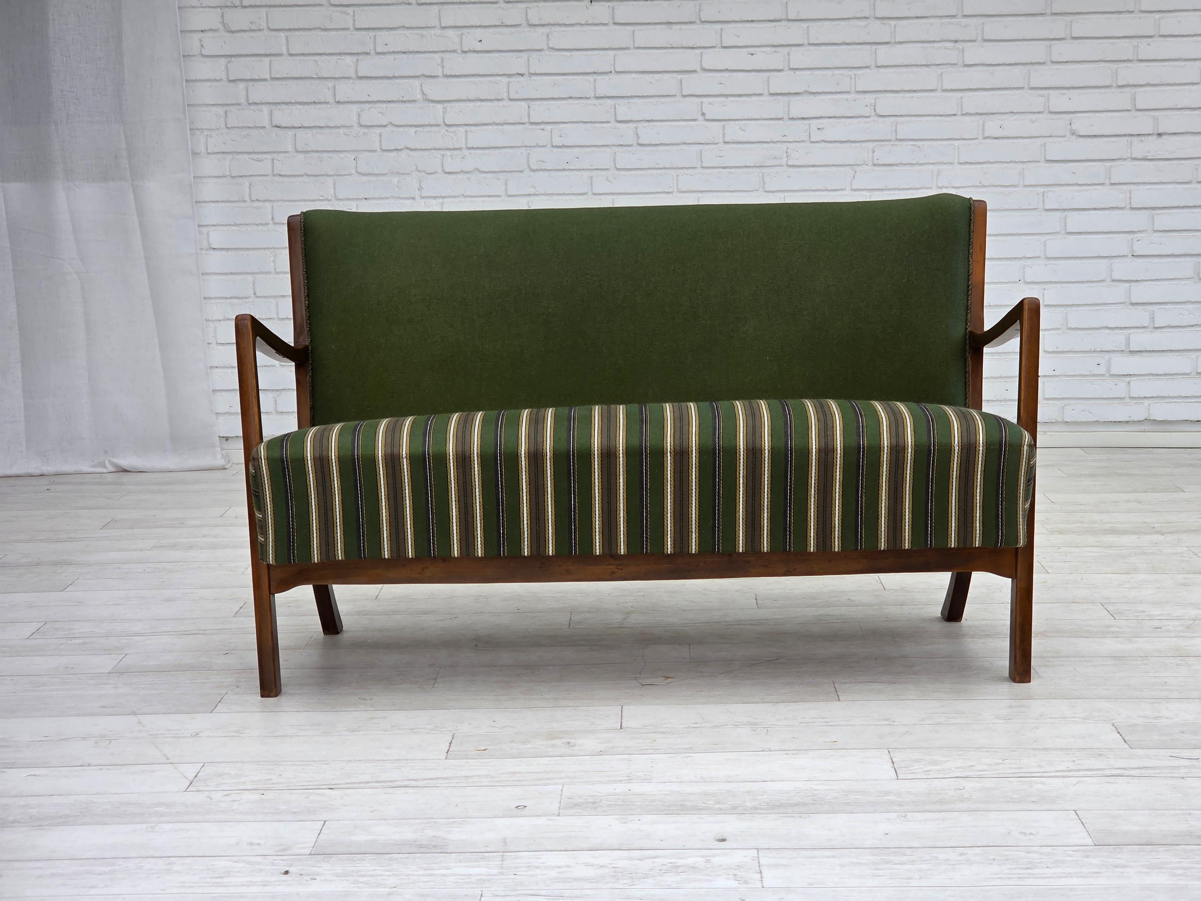 1960s, Danish 2-seater sofa. Original green furniture wool fabric, beech wood, springs in the seat. Original very good condition: no smells, no stains and stable construction. Manufactured by Danish furniture maker in about 1960-65s. Original