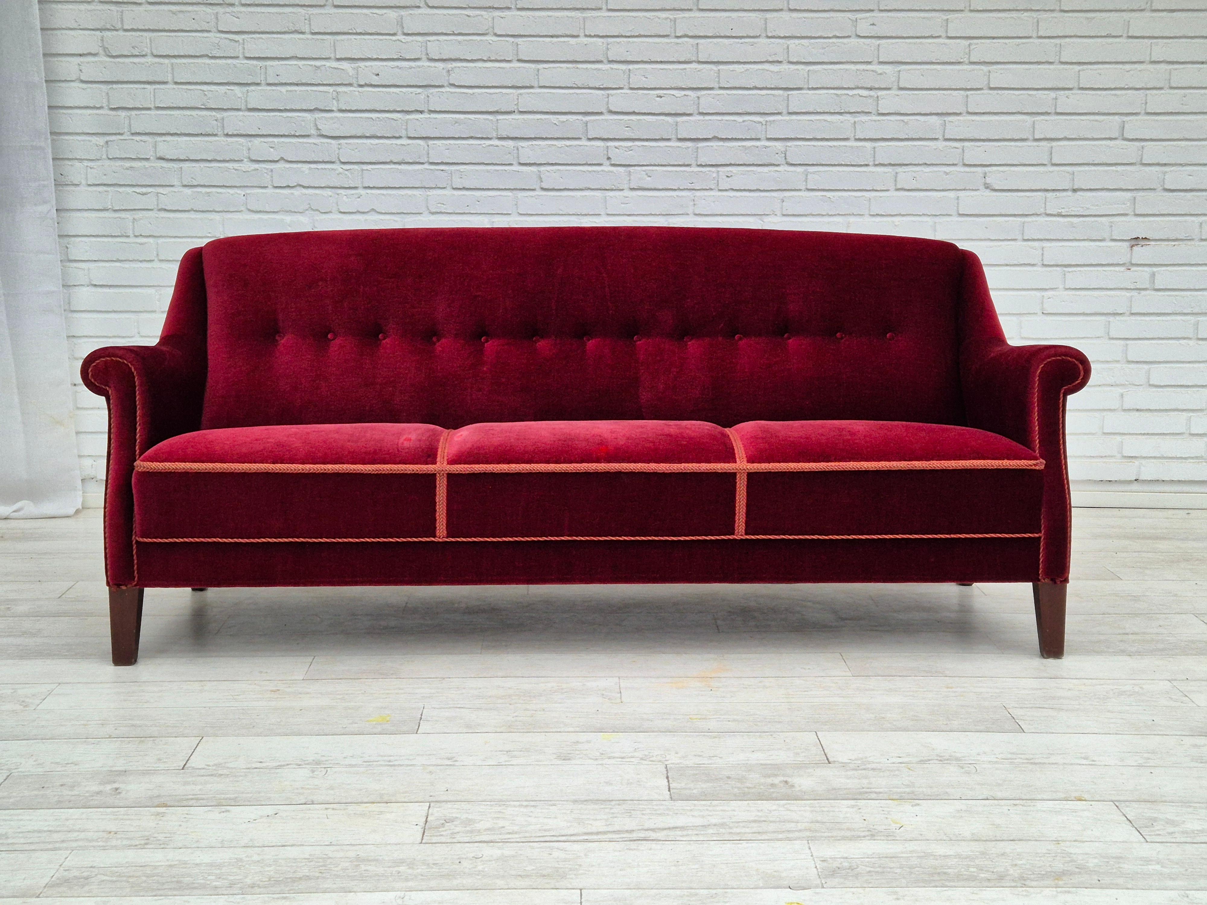 1960s, Danish 3 seater sofa in original good condition. Cherry red furniture velour, beech wood legs, springs in seat. Manufactured by Danish furniture manufacturer in about 1955-60.
