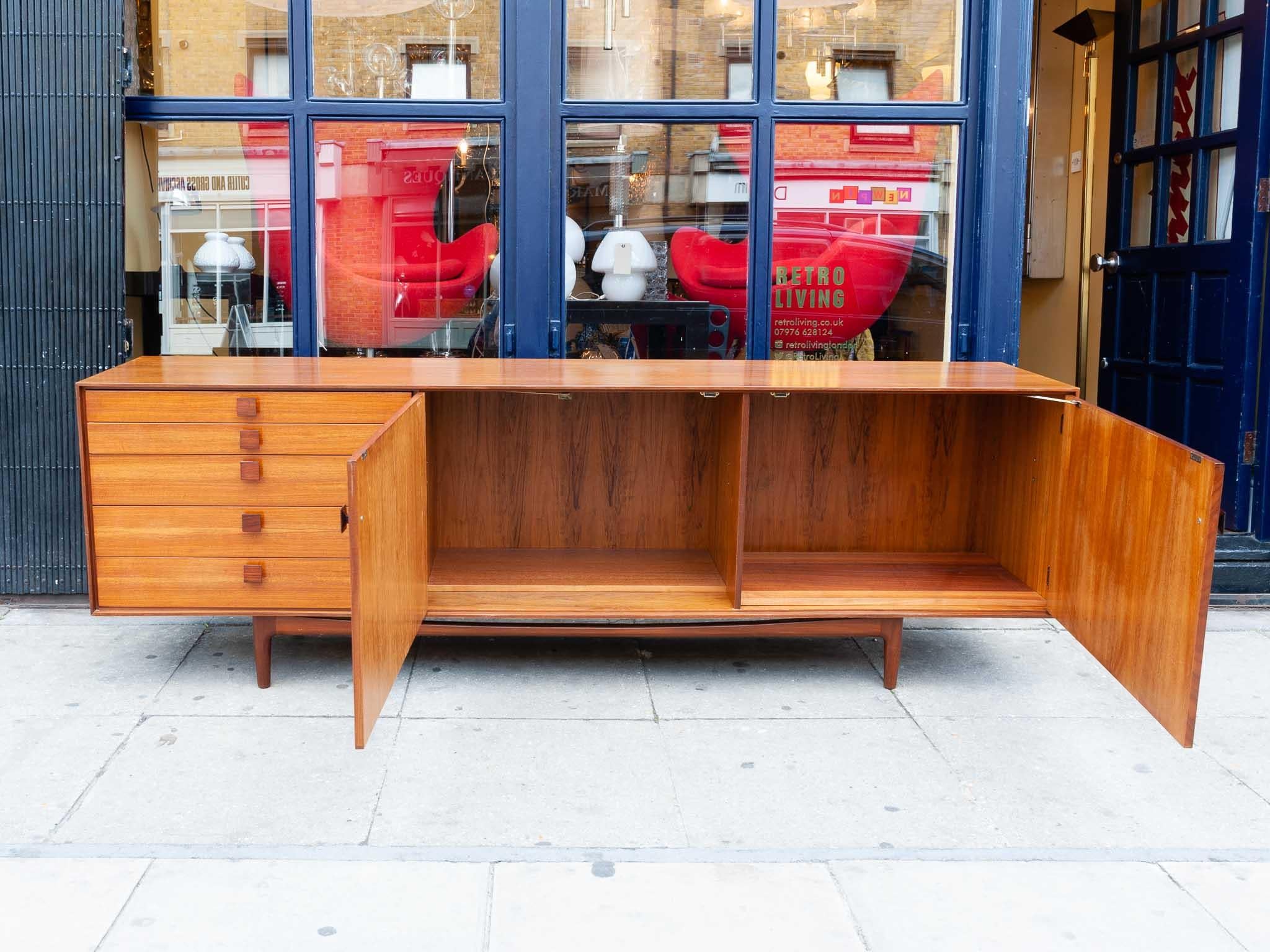 langes Sideboard G Plan aus den 1960er Jahren:: entworfen von Ib Kofod-Larsen. Das Sideboard ist sehr gut aus Afromosia Teak gefertigt. Die Anrichte hat zwei Türen und fünf Schubladen unterschiedlicher Größe:: wobei die oberste Schublade mit Filz