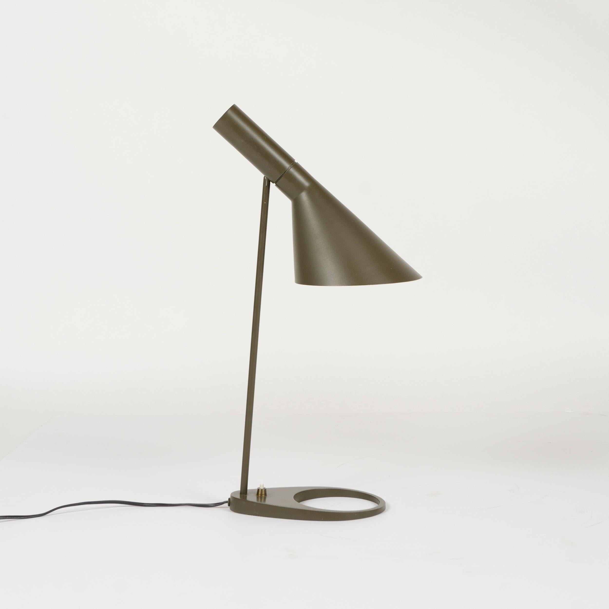 A painted metal desk lamp, having a pivoting 'offset funnel' shade floating above a pierced egg-form base.