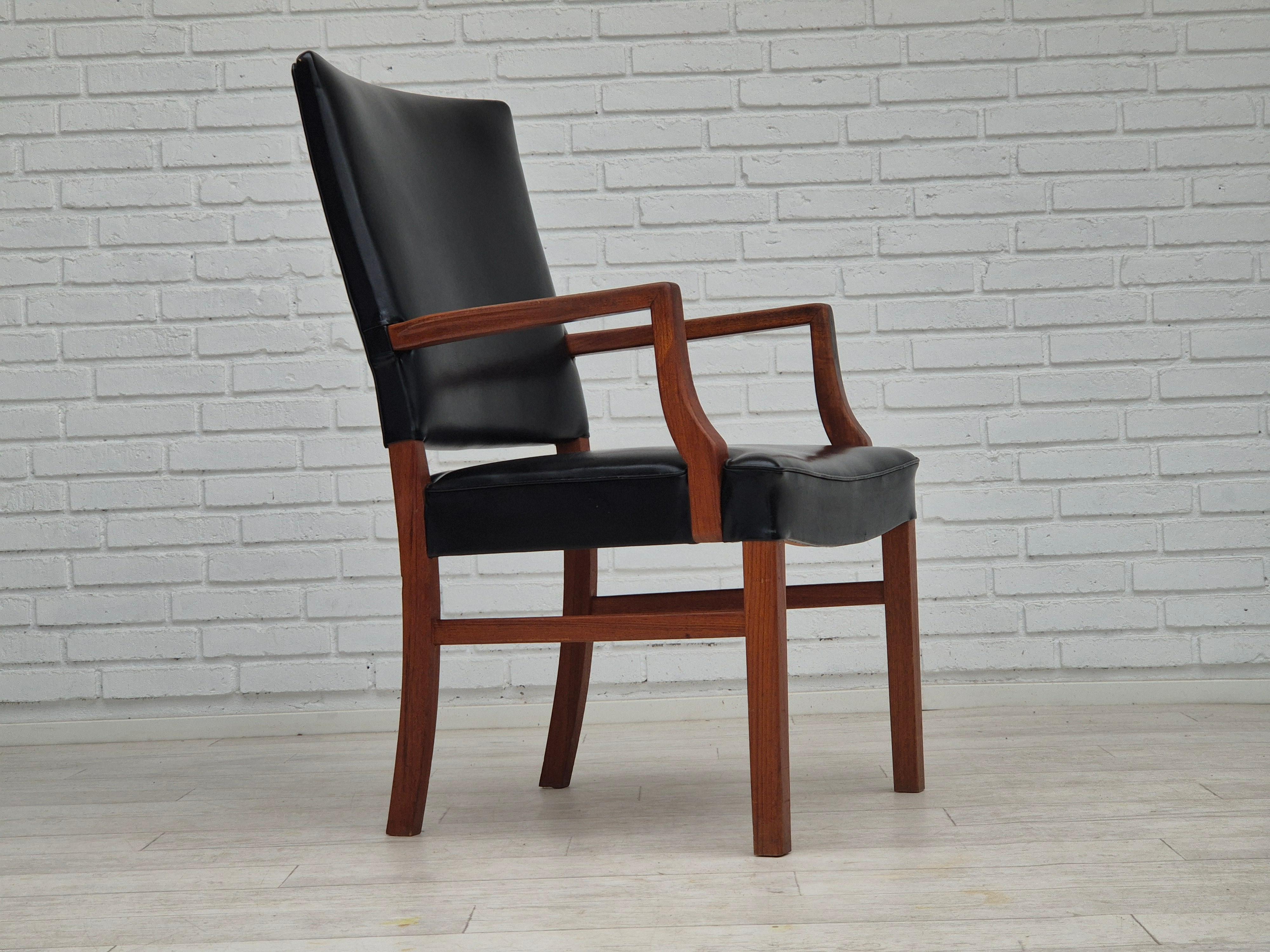 1960s, Danish armchair in original very good condition: no smells, no stains, stable construction. Chair checked by craftsman. Teak wood, artificial leather. Manufactured by Danish furniture maker in about 1960s.