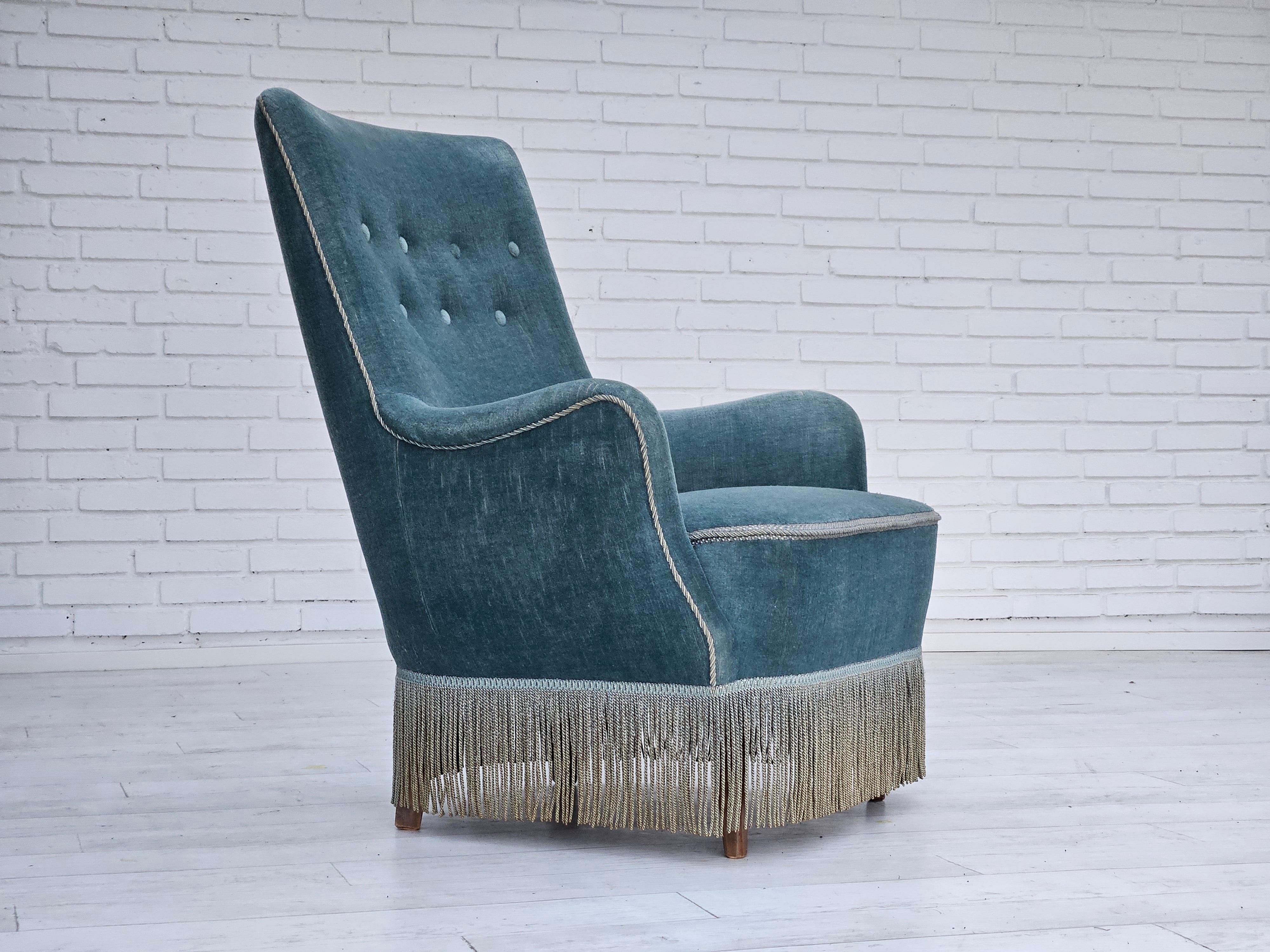  1960s, Danish armchair in original light blue velour. No smells and no stains. Beech wood legs, springs in the seat. Manufactured by Danish furniture manufacturer in about 1960s.