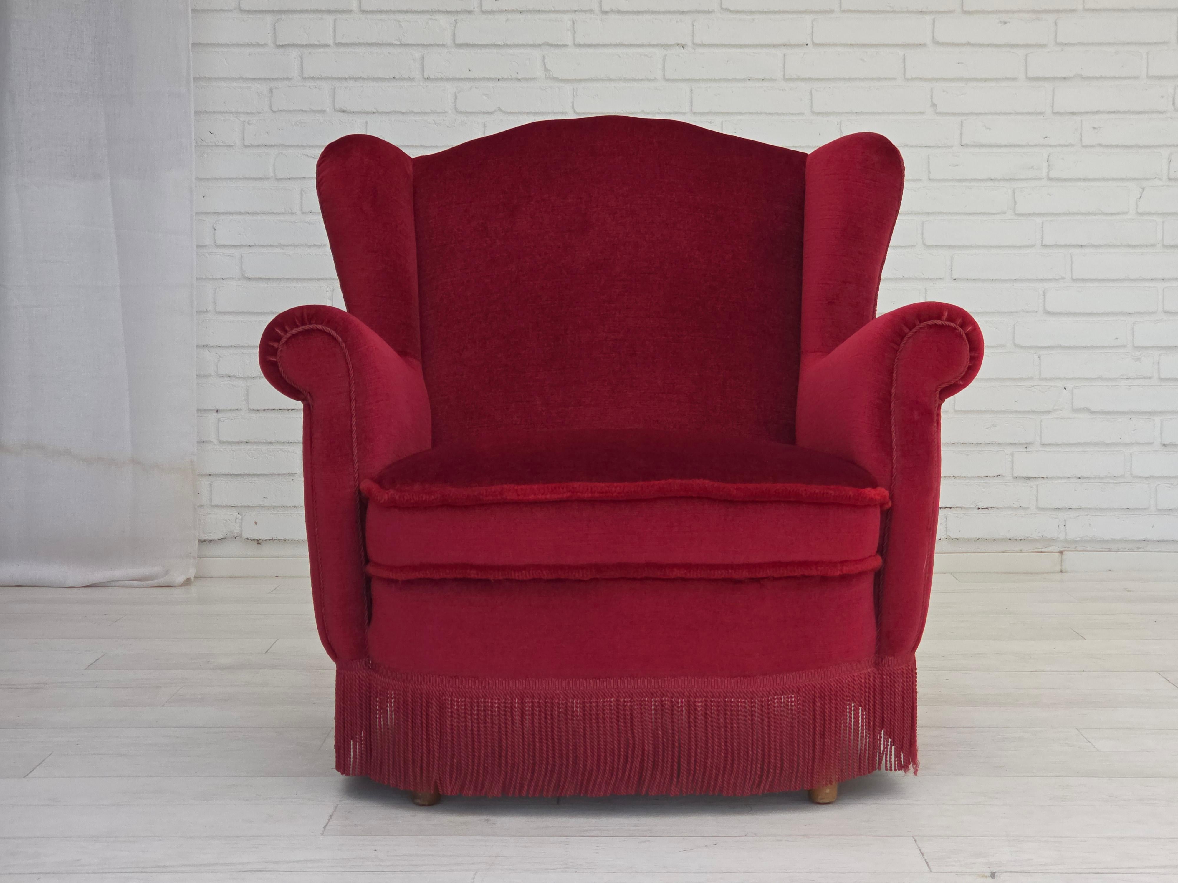 1960s, Danish armchair. Red furniture velour, beech wood legs and springs in the seat. The chair was reupholstered about 15 years ago by craftsman. Very good condition: no smells, no stains and stable construction. Manufactured by Danish furniture