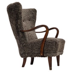 Sillón danés de los años 60, retapizado, piel de oveja auténtica neozelandesa de calidad.