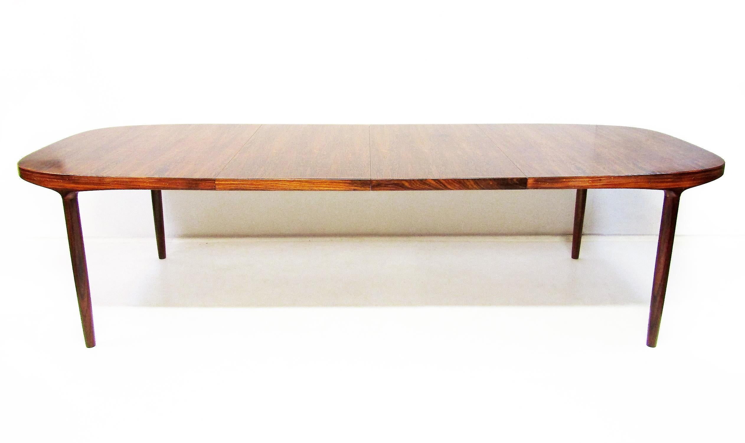 A perfectly proportioned dining or conference table in Rio Rosewood by Danish designer Harry Ostergaard for Randers Mobelfabrik, circa 1960.

Extending up to 280cm, this table has two leaves, which integrate seamlessly with the containing surface.
