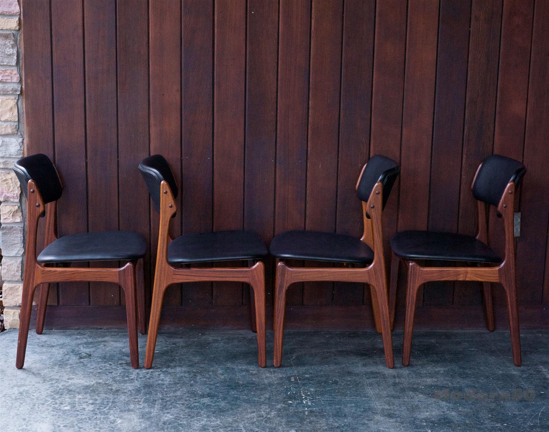 Four Erik Buch dining chairs model OD-49 by Oddense Maskinsnedkeri in Denmark. Ready to use. Rare solid Brazilian rosewood frames, and black vinyl.