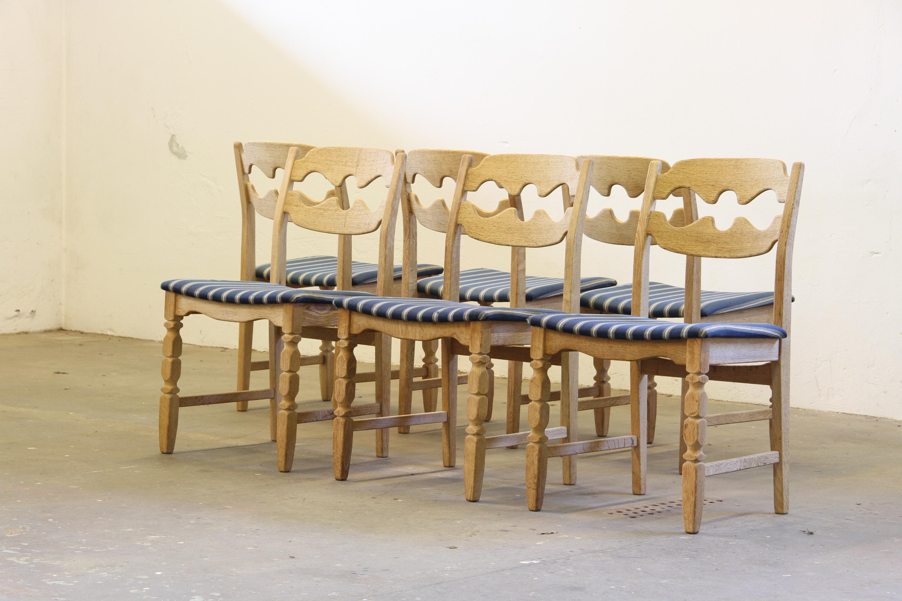 Henning Kjærnulf's dining chairs, crafted from oak and showcase a captivating blend of brutalist/Baroque and Mid-Century Modern influences. Known as the Razorblade model, these classic chairs were produced by Nyrup Møbelfabrik during the