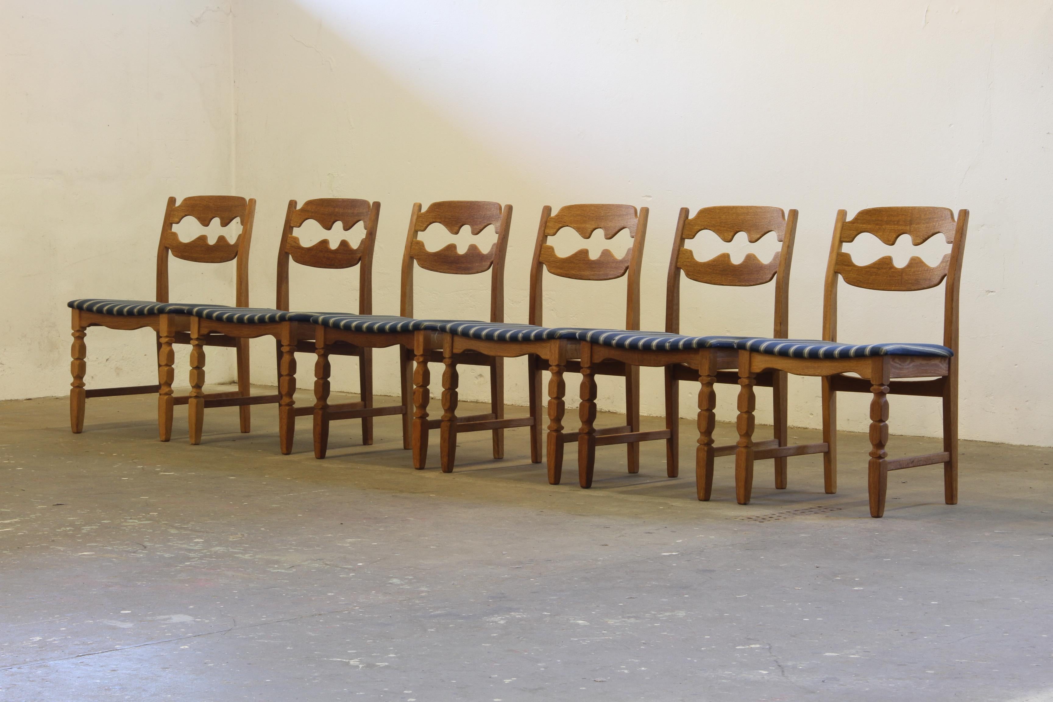 Henning Kjærnulf's dining chairs, crafted from oak and showcase a captivating blend of brutalist/Baroque and Mid-Century Modern influences. Known as the Razorblade model, these classic chairs were produced by Nyrup Møbelfabrik during the