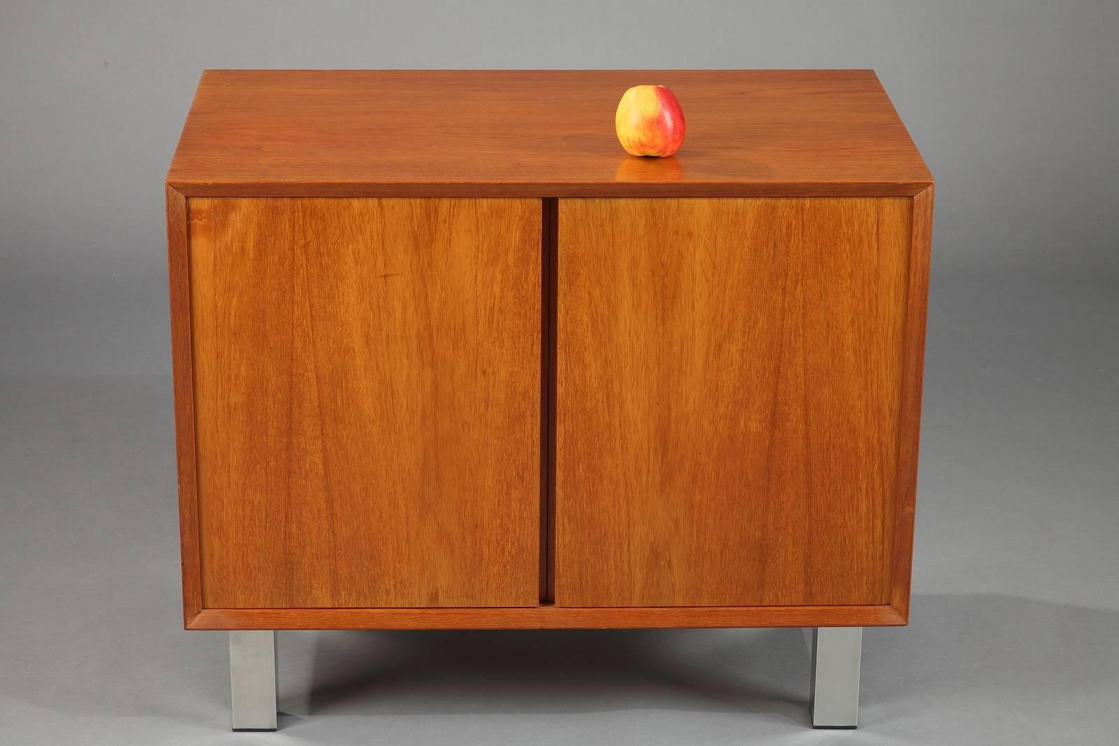 Cabinet in teak veneer from the 1960s. The two doors open to display a storage compartment with one shelve. It rests on four aluminum feet. The pure and sober lines are typical of the Scandinavian Modern style. 

circa 1960
Dimension: W 31.5 in,