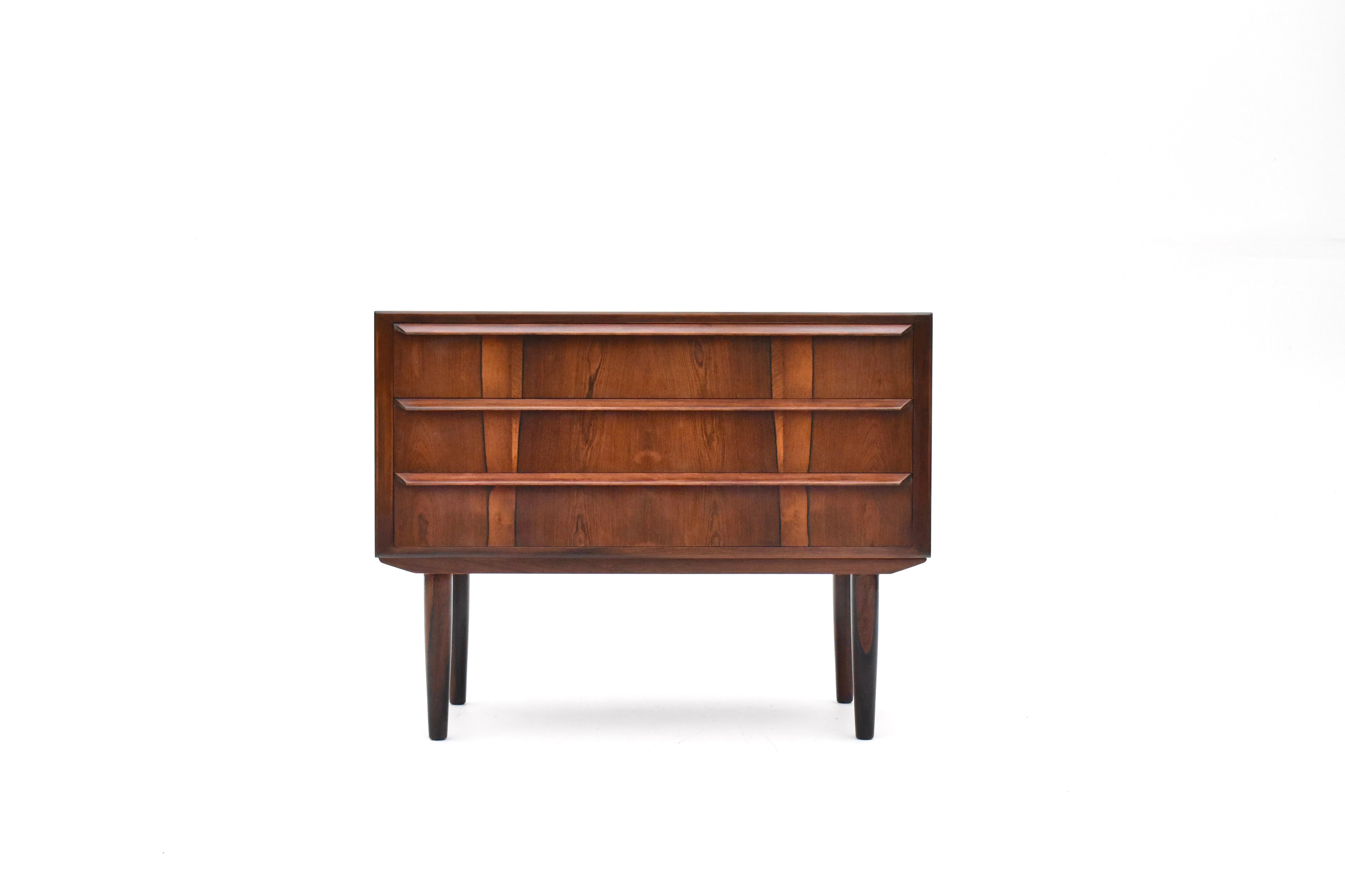 A superb Danish cabinetmaker chest of drawers finished in vivid Brazilian rosewood.

This is only the third example of this design we have seen in nearly 20 years of collecting. We have not been able to identify the maker or designer however they