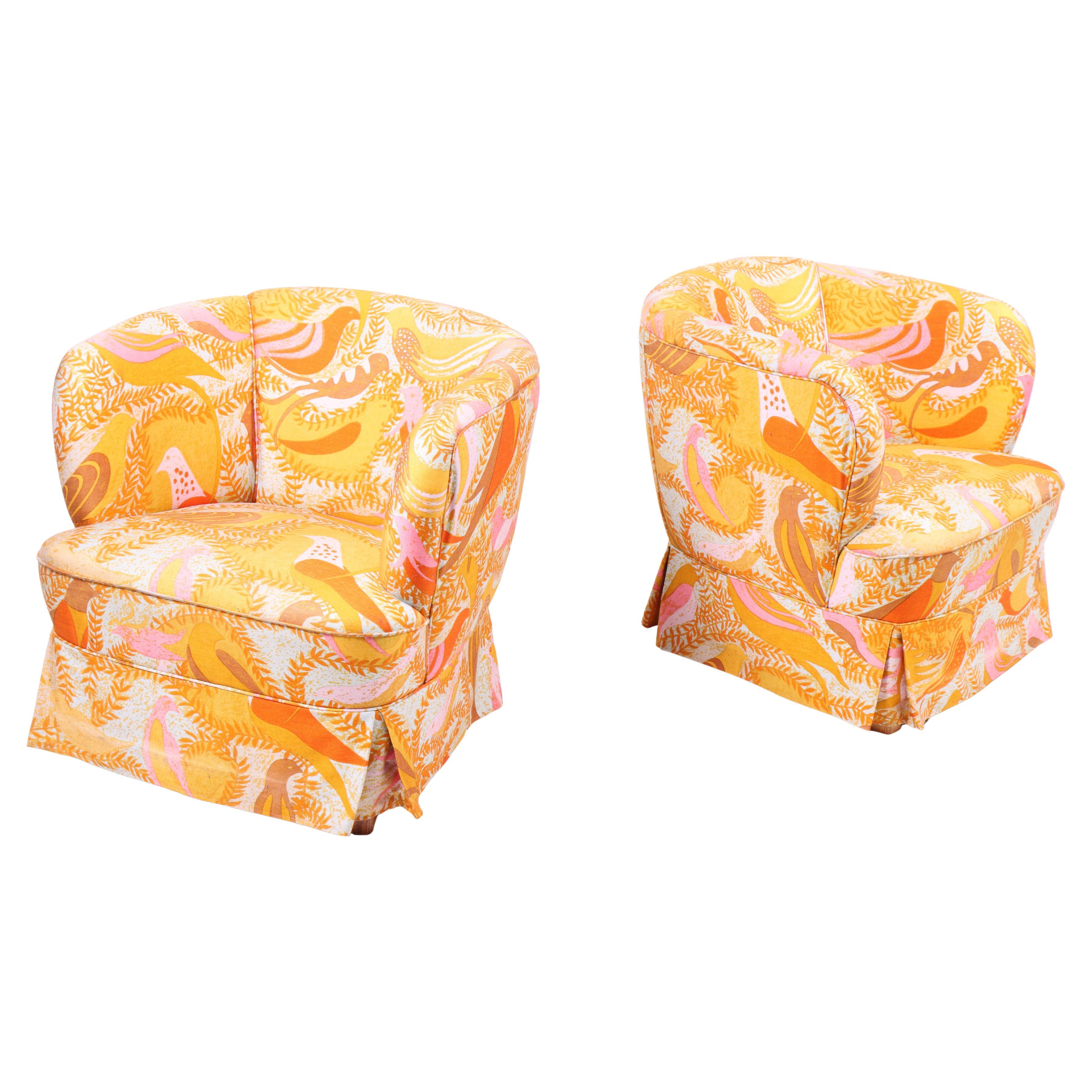 1960s Danish chairs with curved shape, colorful fabric, and elegant skirt.
