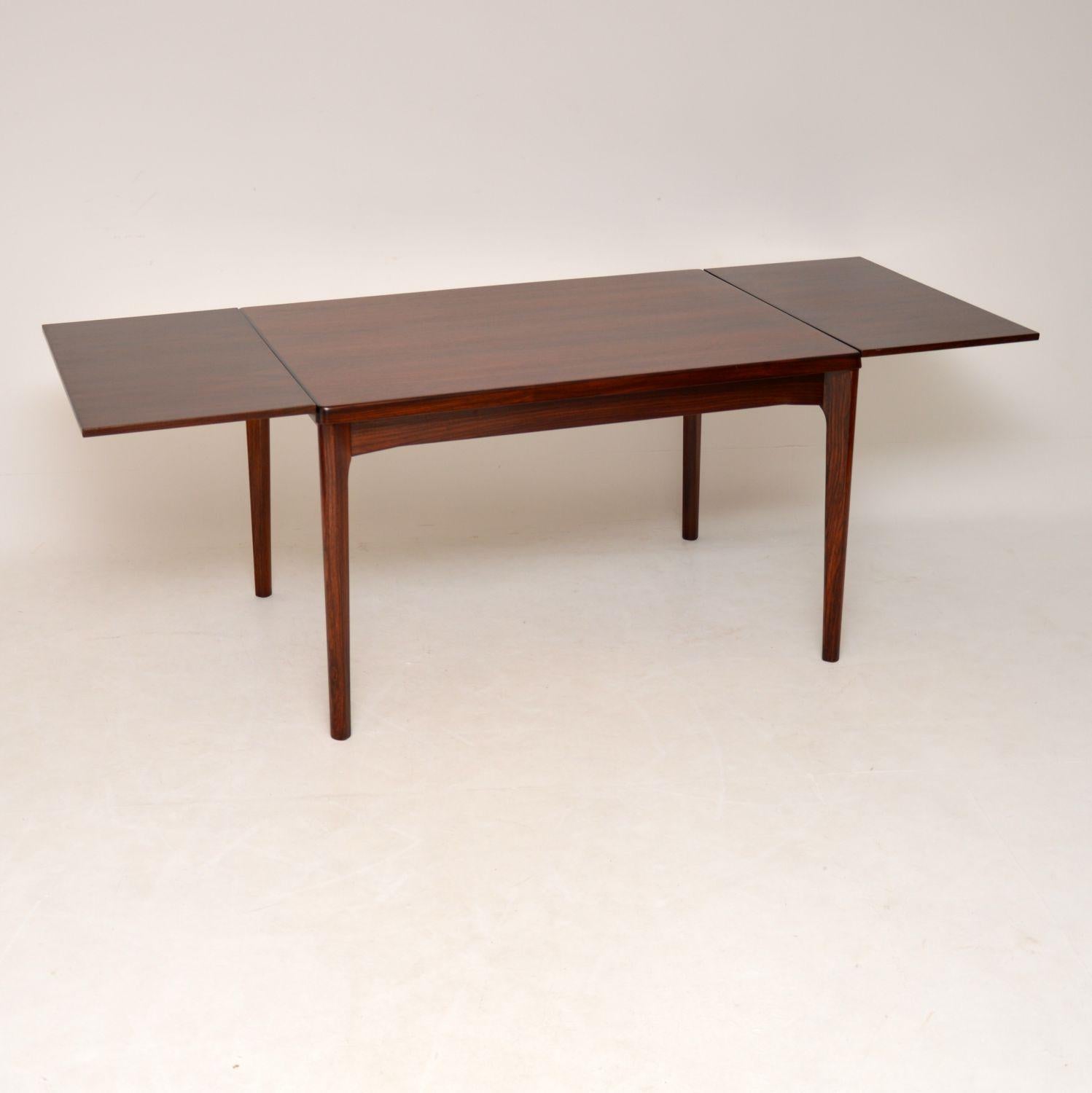 A beautifully made and very stylish Danish vintage dining table, this dates from the 1960s. It was made by Vejle Stolefabrik and was designed by Henning Kjaenulf. It’ has a clever design, the extending draw leaves on each side are beautifully