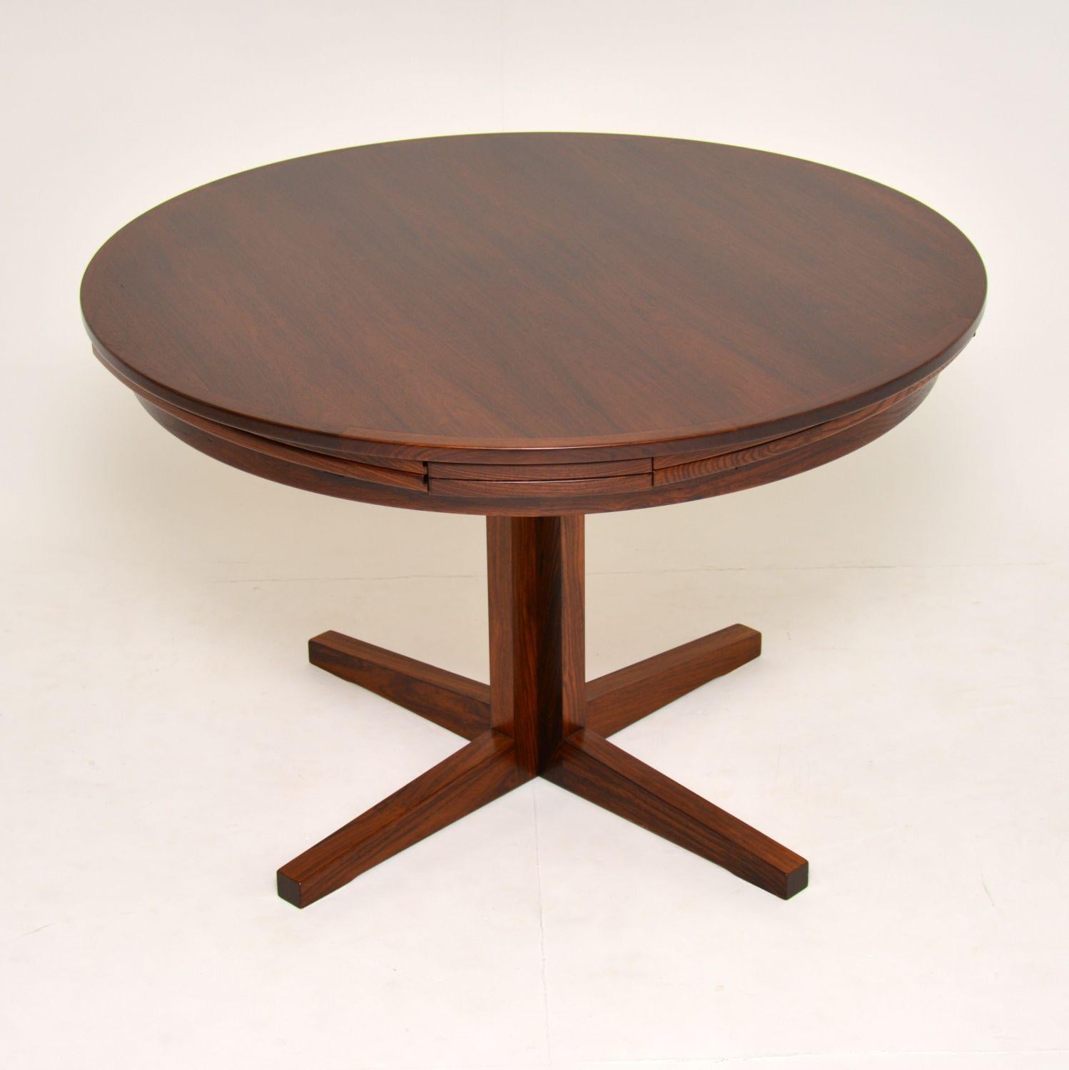 A stunning Danish wooden dining table by Dyrlund, this is the famous flip flap lotus table, it dates from the 1960’s. This is a very rare version, with a single column pedestal and a slightly smaller top and leaves than normal. The quality is
