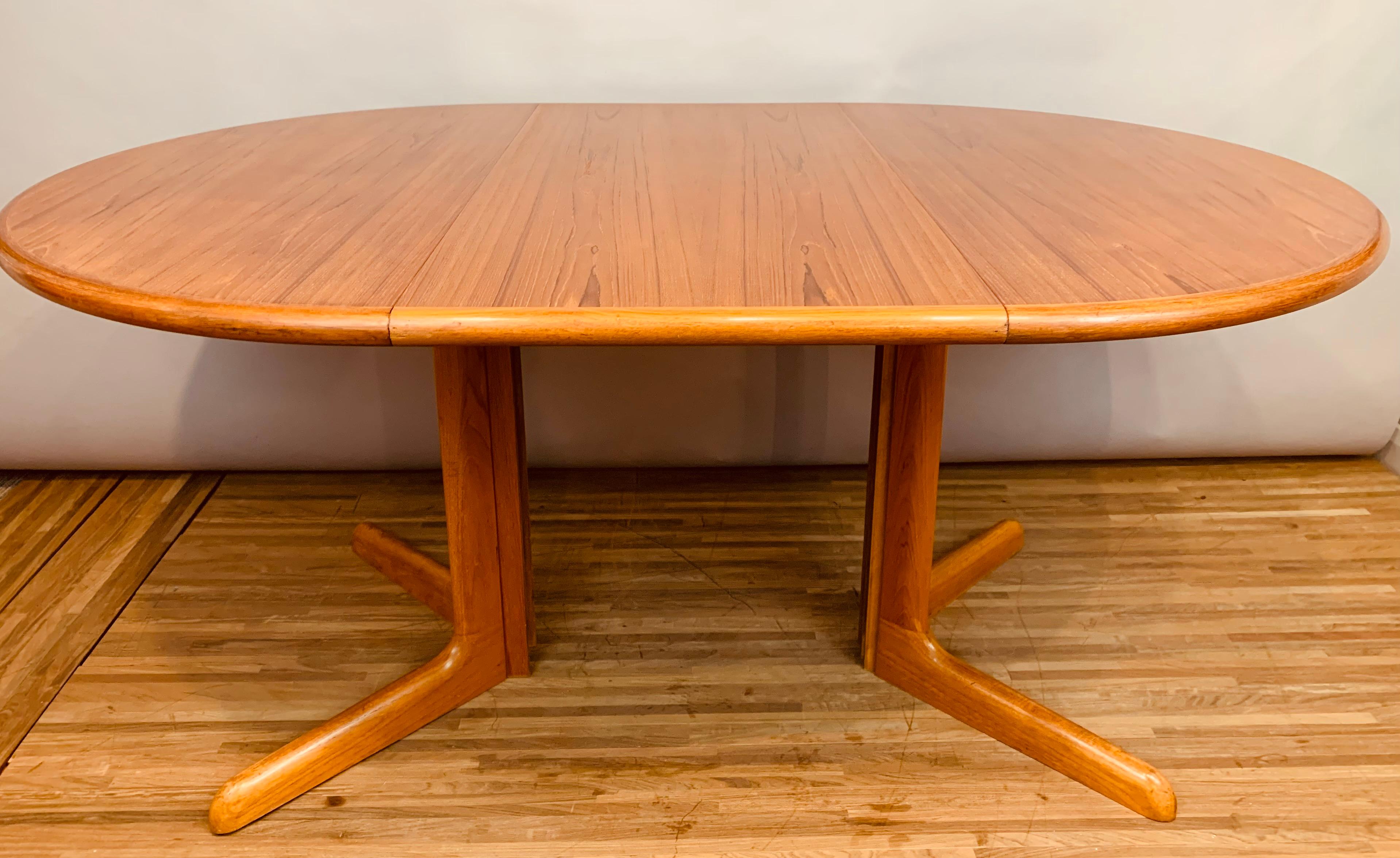 1960s Danish Gudme Møblefabrik Teak pedestal dining table with one single leaf measuring 49 cm wide. Attributed to the designer Niels Otto Møller. The original maker's label is still in tact on the underside of the table top - Gudme Møblefabrik A/S