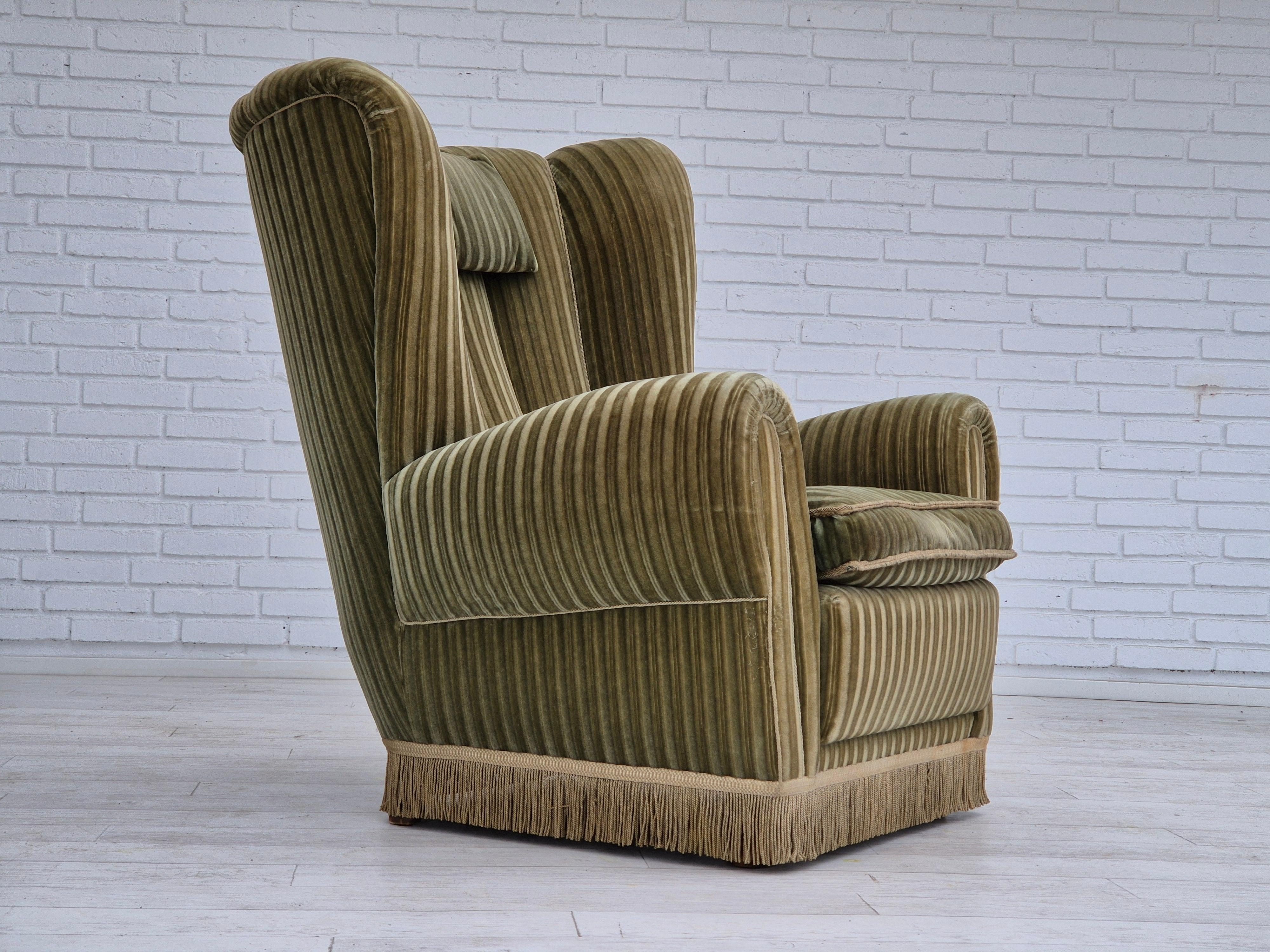 Fauteuil relax danois à dossier haut des années 1960 en très bon état d'origine : pas d'odeurs ni de taches. Velours d'ameublement vert d'origine. Ressorts dans l'assise, pieds en bois de hêtre. Fabriqué par un fabricant de meubles danois dans les