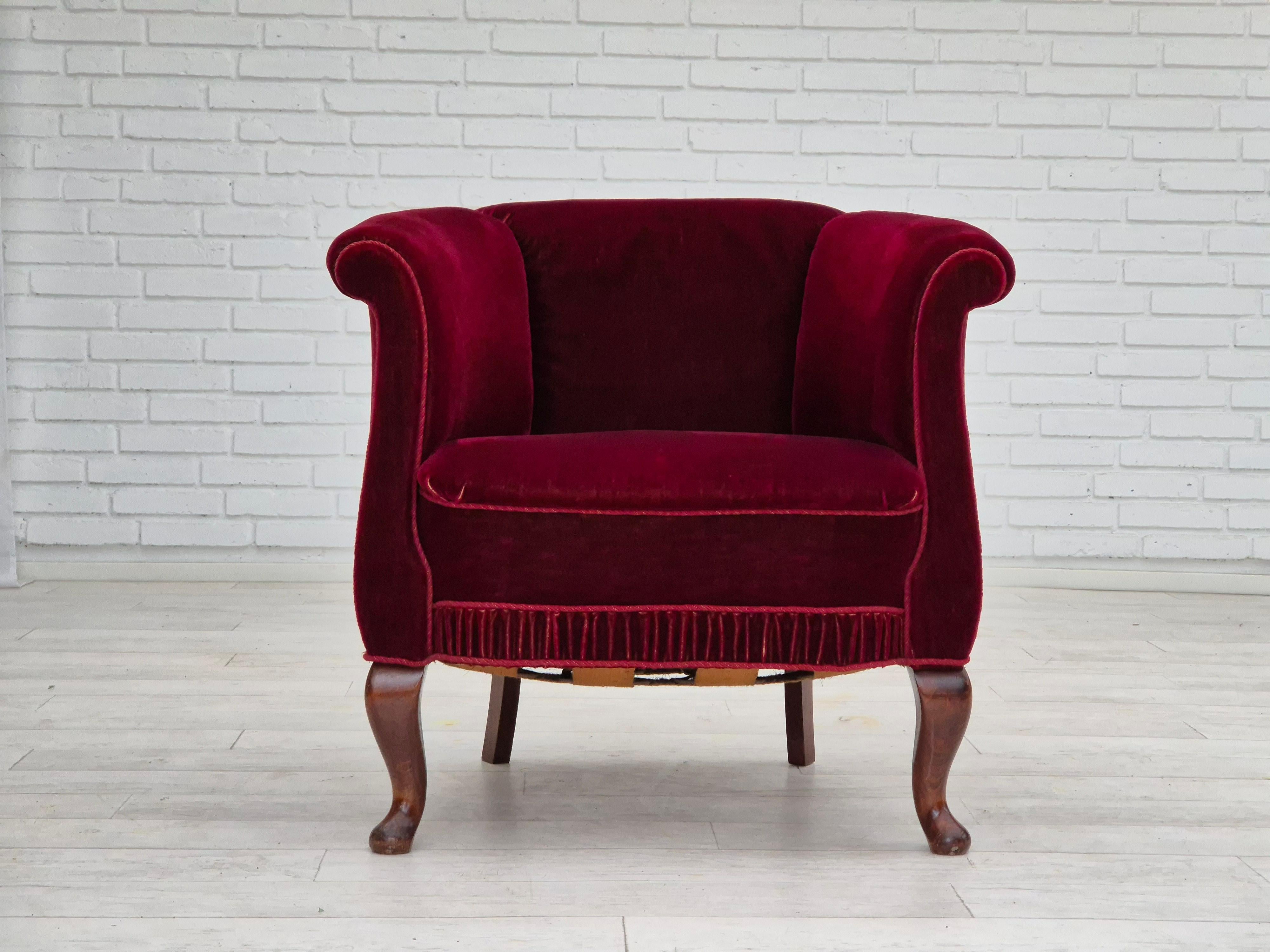 1960s, Danish lounge chair in cherry-red furniture velour. Original very good condition: no smells and no stains. Beech wood legs, brass springs in the seat. Manufactured by Danish furniture manufacturer in about 1955-60s.