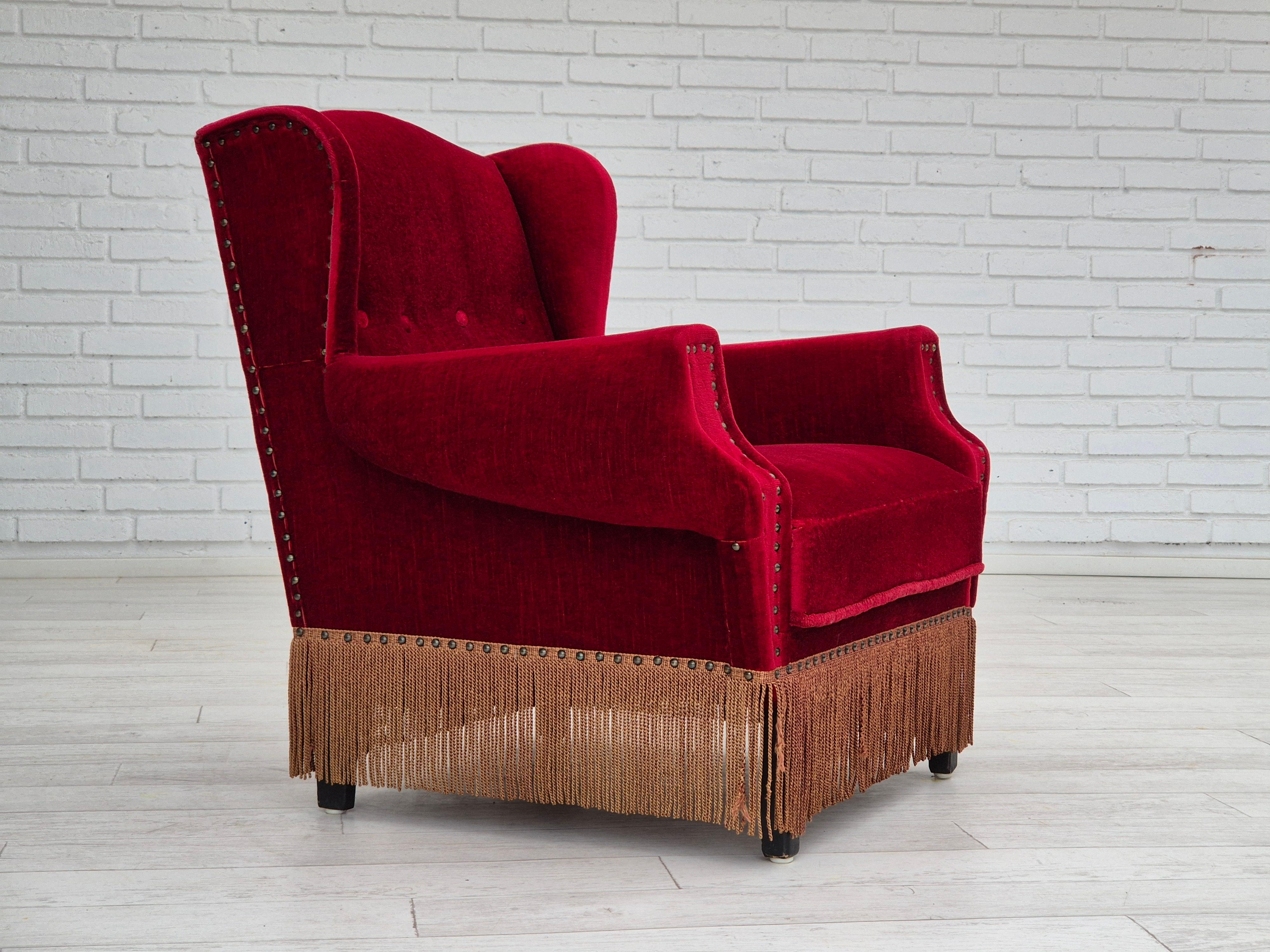 1960s, Danish lounge chair in original very good condition: no smells and no stains. Cherry-red furniture velour, oak wood legs. Springs in the seat. Manufactured by Danish furniture manufacturer in about 1960s.