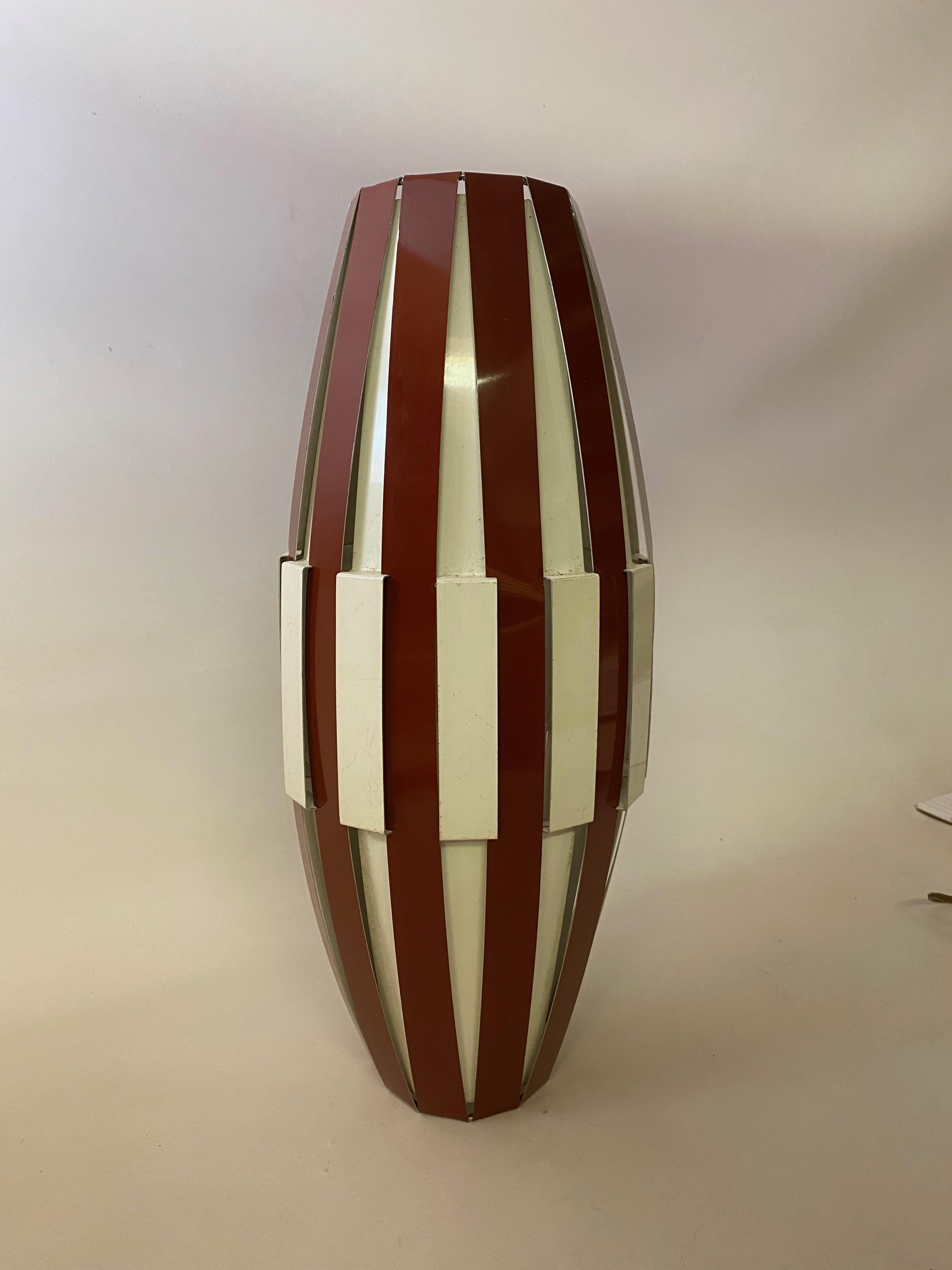 Oblong shaped metal lattice pendant light fixture. Brown and white interwoven metal straps, circa 1965. Possibly a Louis Weisdorf design for Lyfa, Denmark. The light source and bulb socket holds the shade in place. Very good condition with very