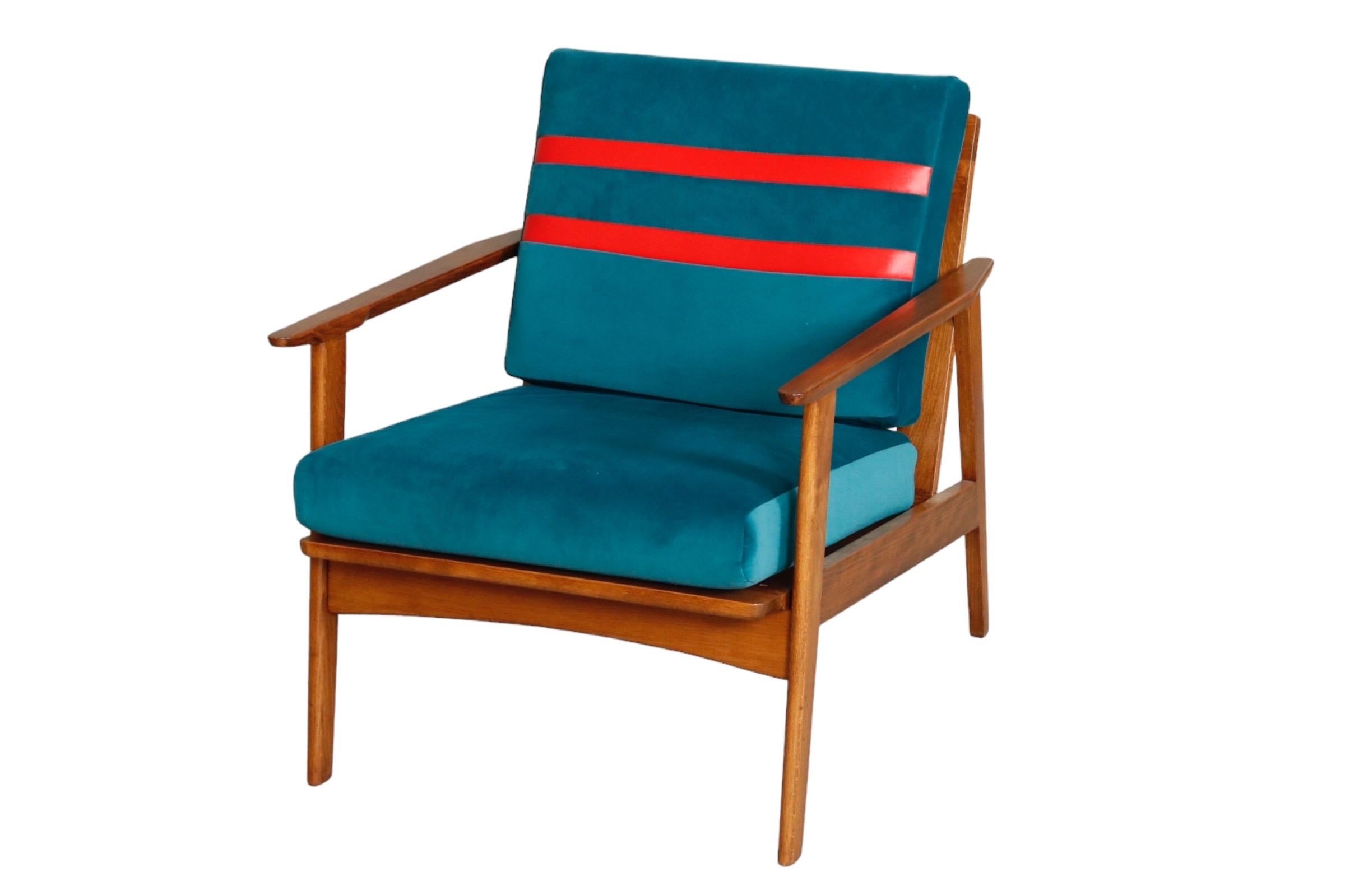 A 1960’s Danish mid century modern lounge chair made of solid teak. New upholstery with teal velvet and red striped cushions.