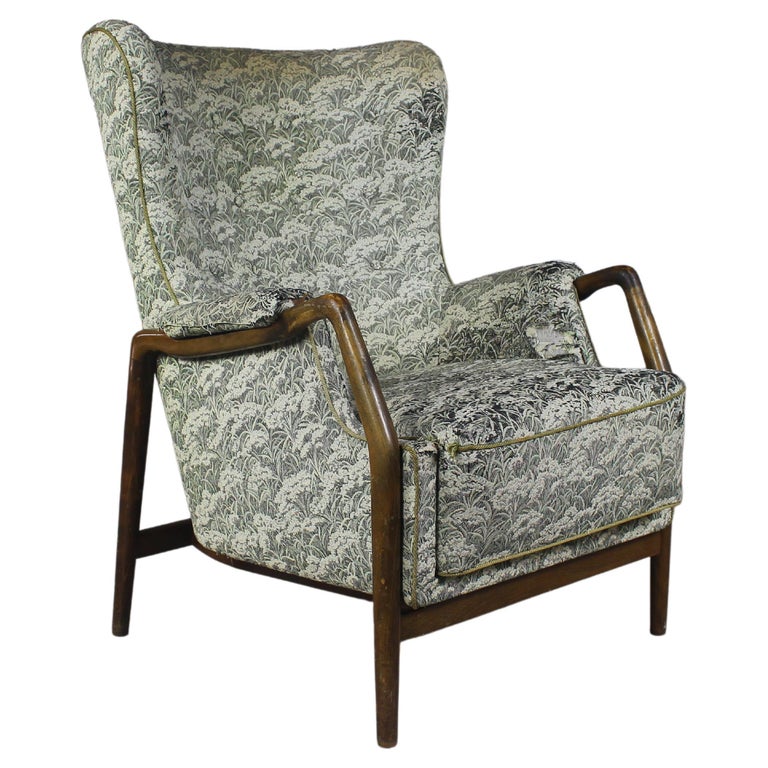 Kurt Olsen sculptural armchair upholstered in floral motif fabric on crafted wooden frame.
Modern Danish design armchair from 1960’s.