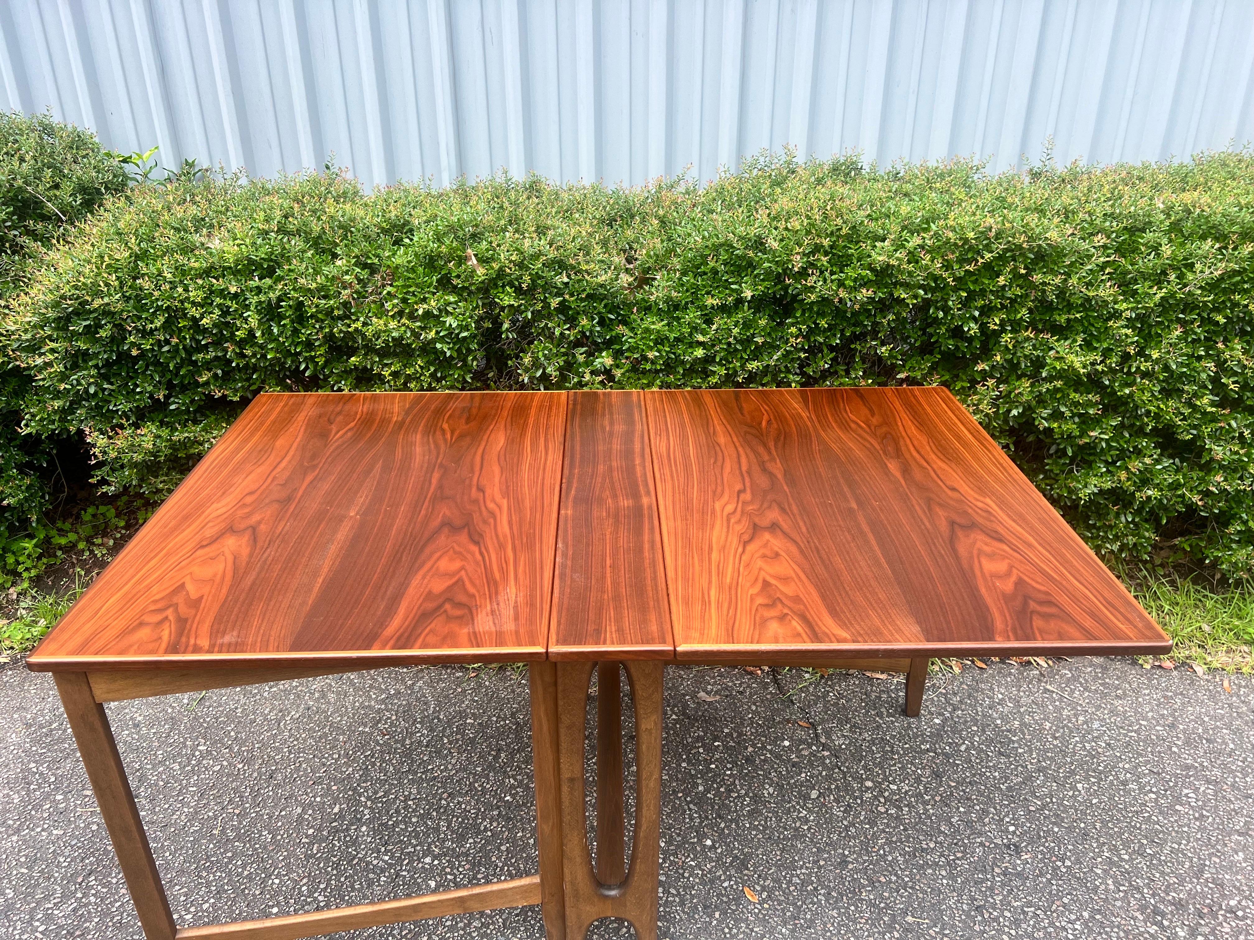 An exceptional work of Danish craftsmanship. This is an outstanding selection for serious collectors of mid century modern Danish. The leaves hang from the table, with original reinforced hinges, allowing functionality a statement to the