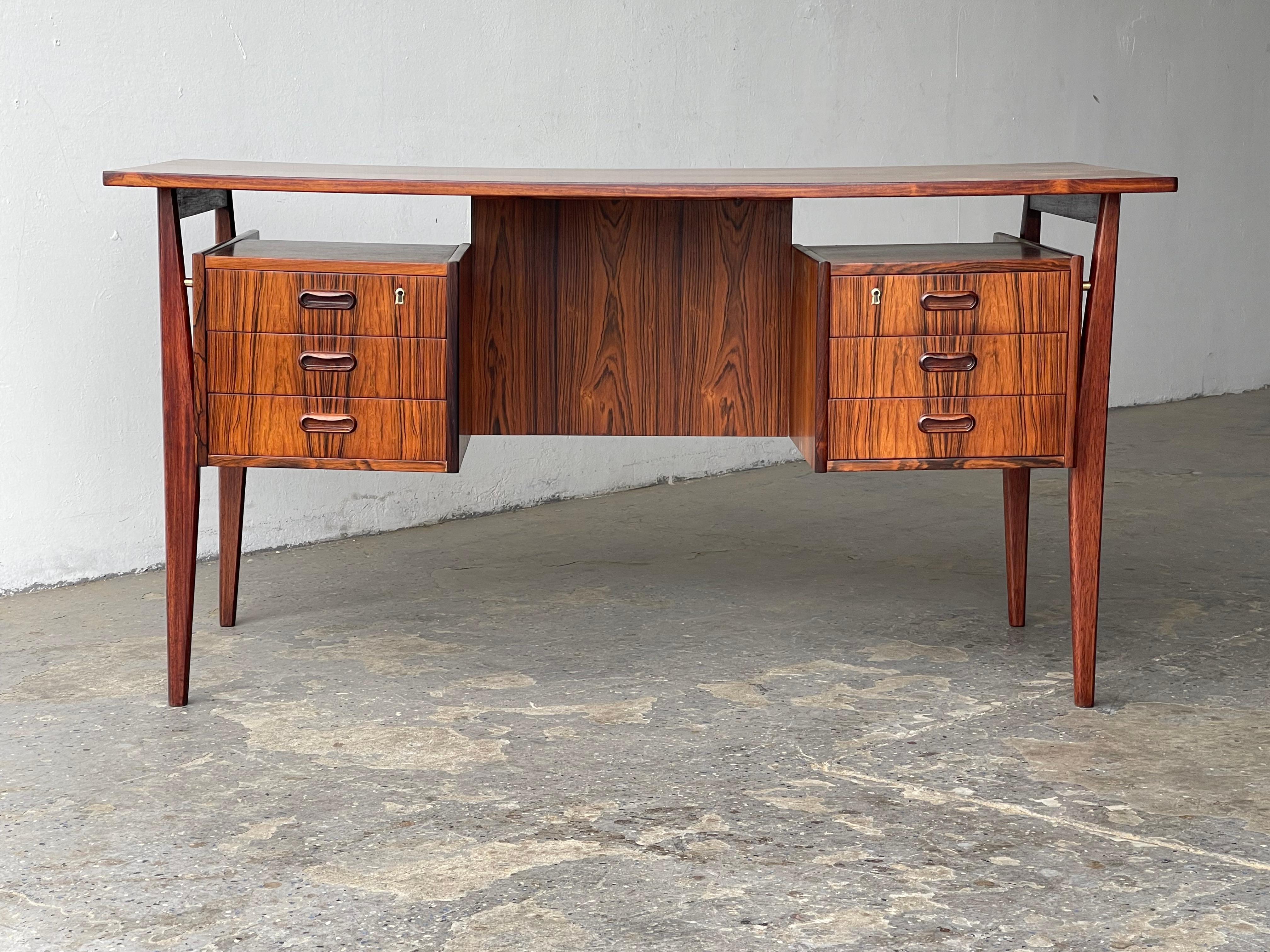 Designed by Gunnar Nielsen for Tibergaard in 1960's Denmark, this exquisite writing desk would make a stylish addition to any home or office environment.

This writing desk boasts Nielsen's flair for style, form and functionality with no detail