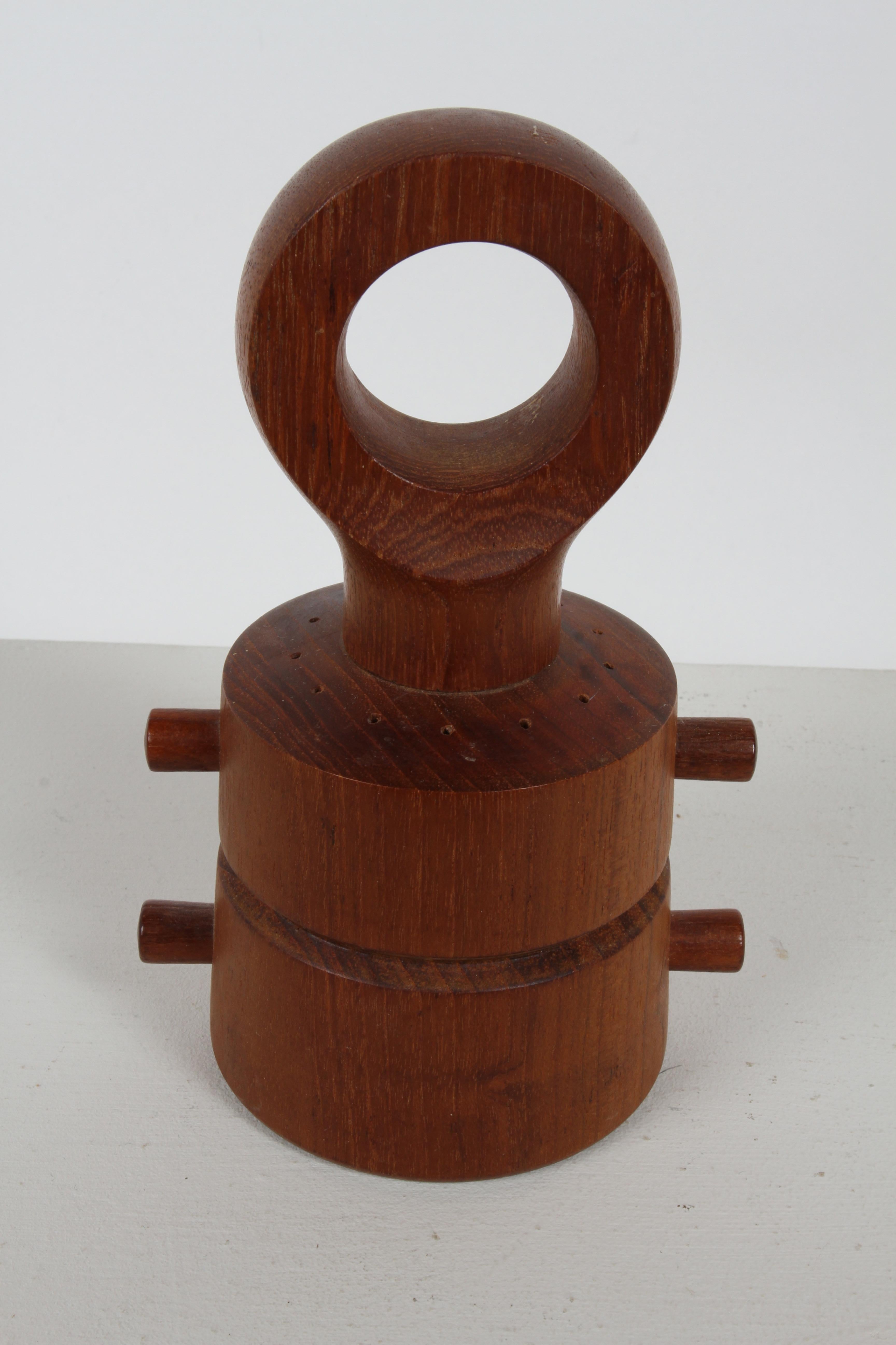A 1960s Danish Modern Jens Quistgaard Salt & peppermill made of teak, with open ring handle and two cylinder compartments. Stamped Dansk Designs Ltd Denmark JHQ. Nice original condition. 

Ground pepper comes out of the bottom when top turns and