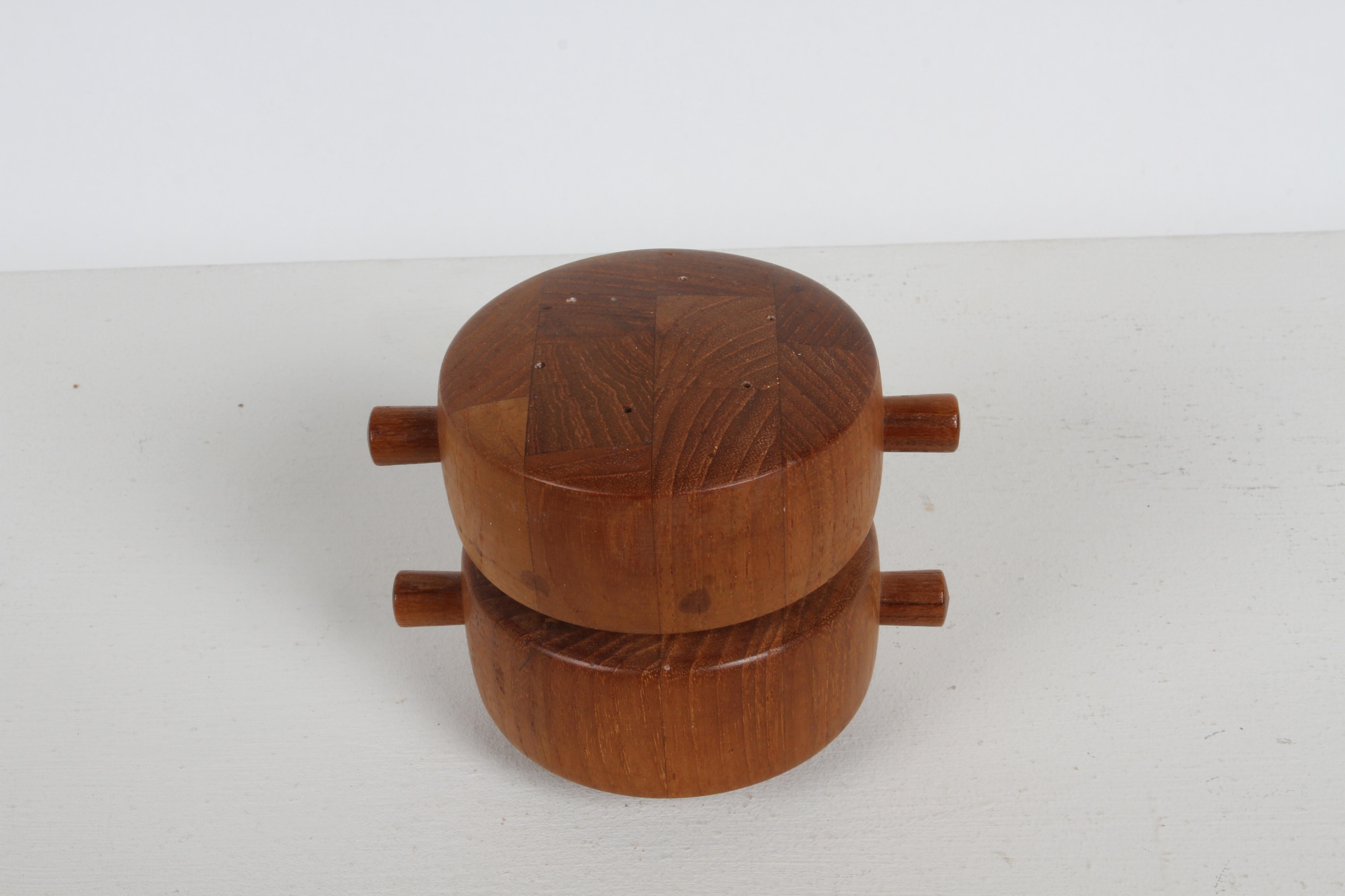 A 1960s Danish Modern Jens Quistgaard Salt & peppermill made of teak, with two cylinder compartments. Stamped Dansk Designs Ltd Denmark JHQ. Nice original condition. 

Ground pepper comes out of the bottom when cylinder turns and salt sprinkles from