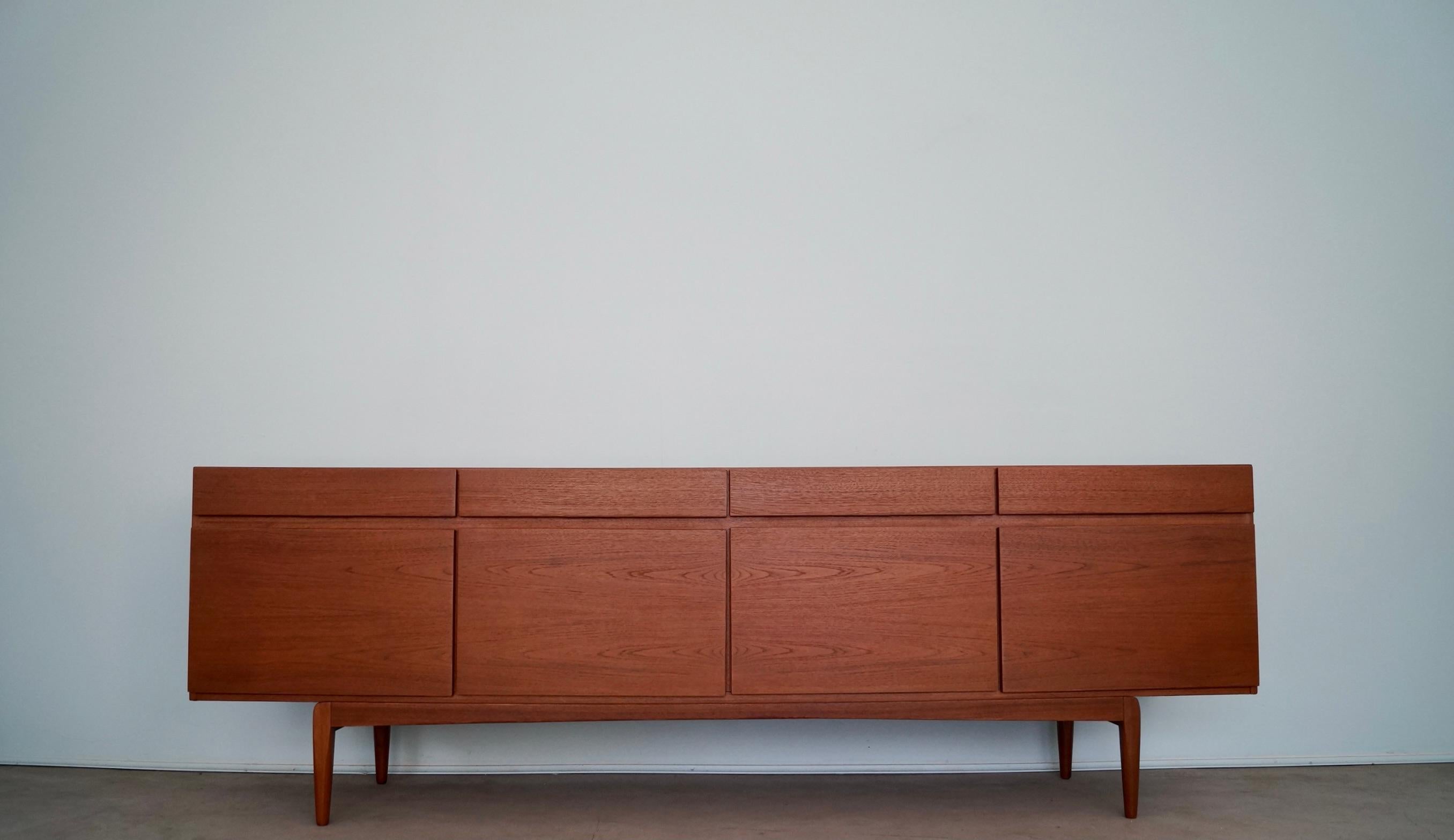 Original Mid-century Danish Modern credenza for sale. It was designed by IB Kofod-Larsen in the 1960's, and is a stunning work of art. It was manufactured by Faarup Mobelfabrik, and is an exceptional piece. It's made of teak, and has been